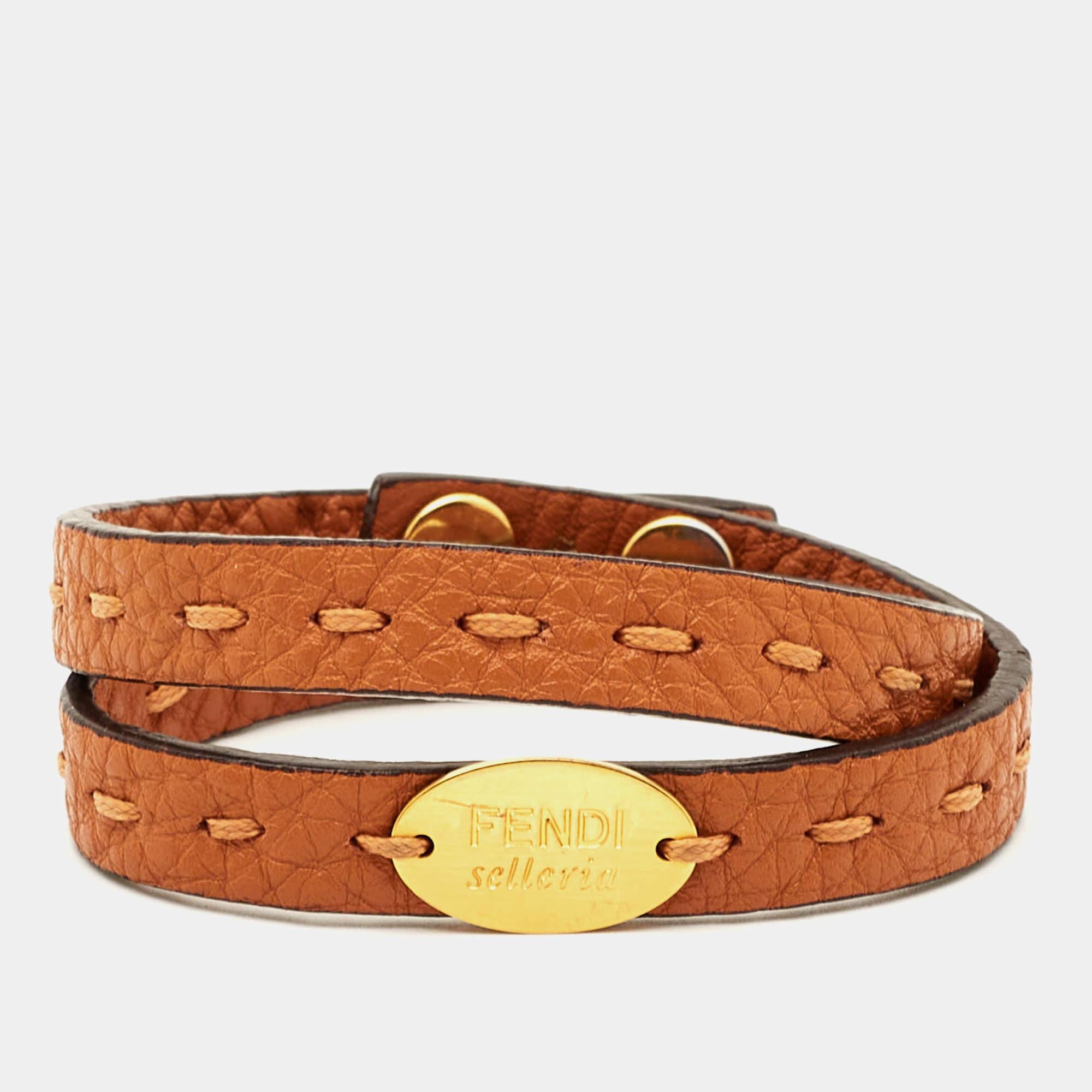 This Fendi double-wrap bracelet is made of leather and gold-tone metal. It has the Selleria all over for a signature finish.

