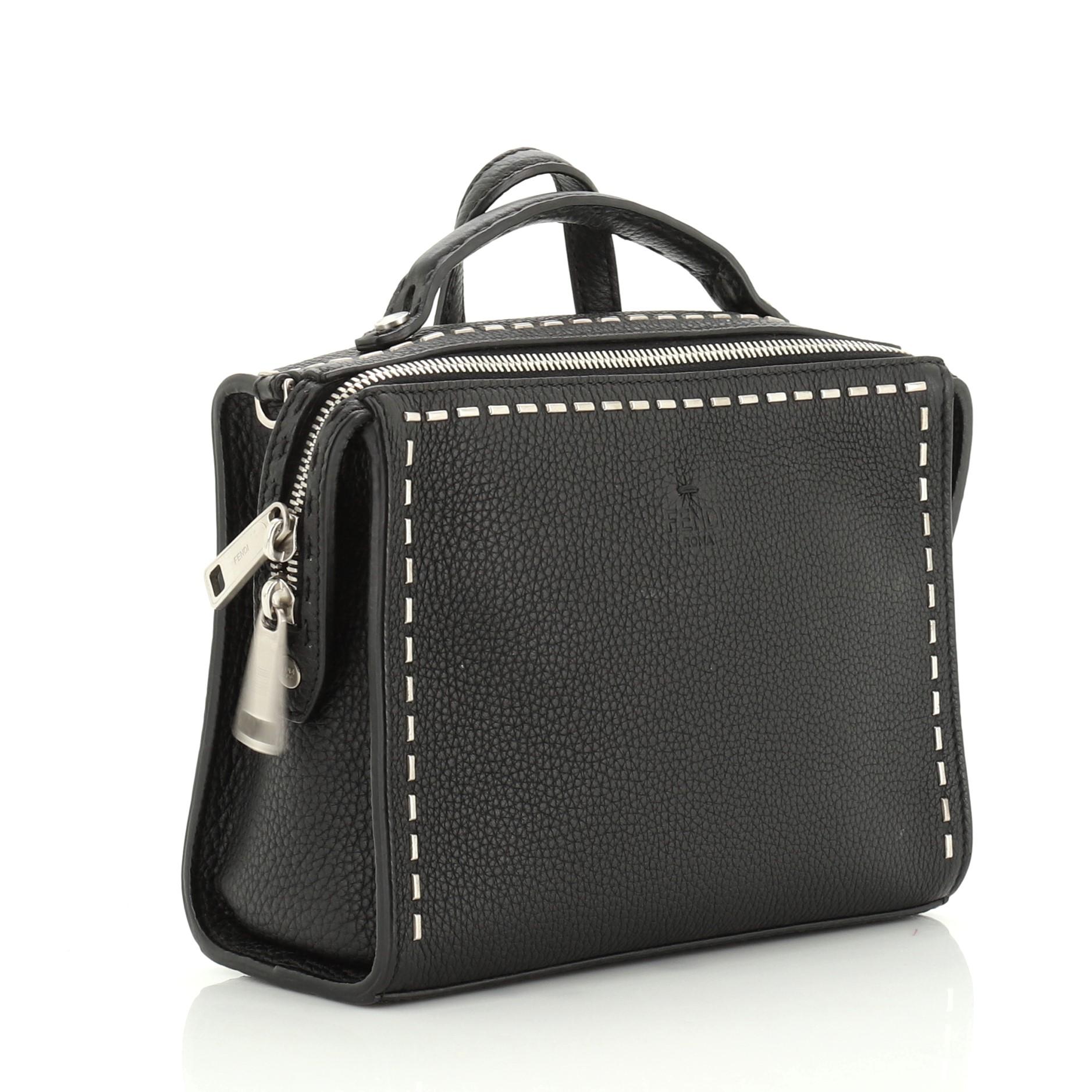 This Fendi Selleria Messenger Bag Studded Leather Mini, crafted in black leather, features a leather top handle, and matte silver-tone hardware. Its zip closure opens to a black fabric interior. These are professional pictures of the actual bag
