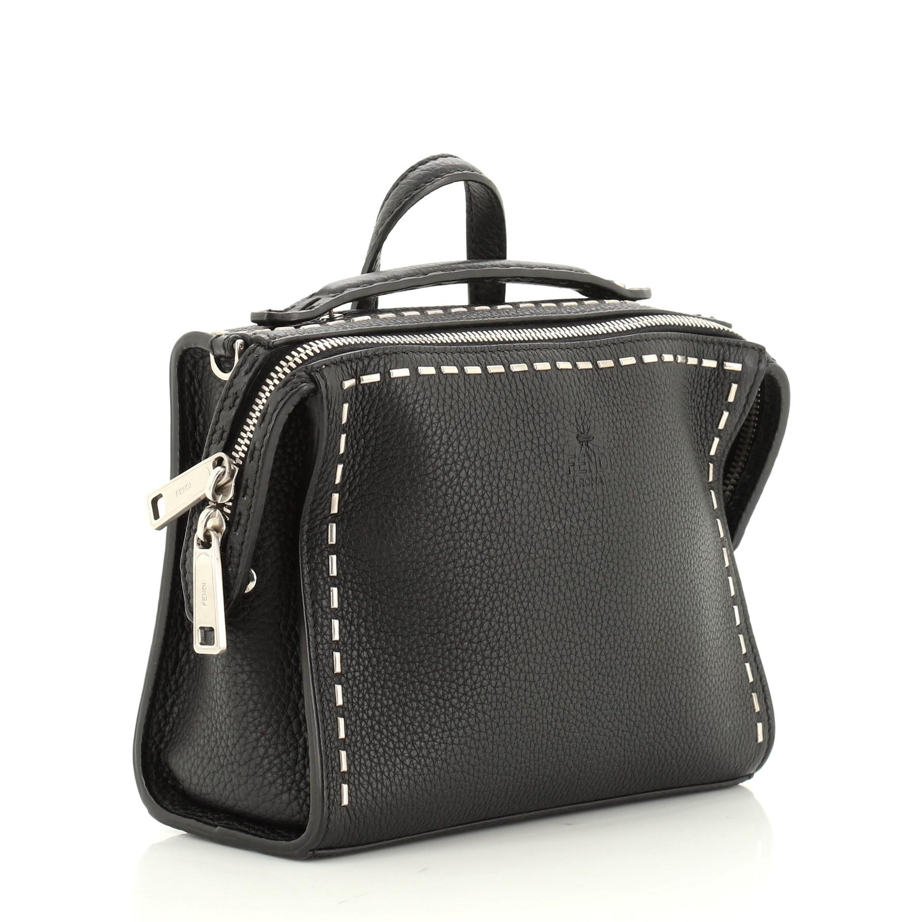 This Fendi Selleria Messenger Bag Studded Leather Mini, crafted in black leather, features a leather top handle, and matte silver-tone hardware. Its zip closure opens to a black fabric interior. 

Estimated Retail Price: $2,100
Condition: Damaged.