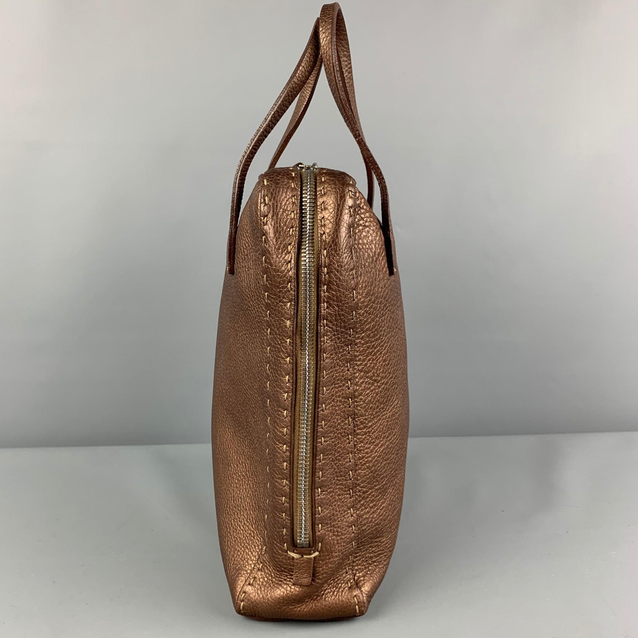 FENDI 'SELLERIA' bag comes in a copper pebble grain leather featuring top handles, top stitching, inner slots, top handles, and a dual zipper closure. Made in Italy.
Very Good
Pre-Owned Condition. 

Marked:   N49-11859 

Measurements: 
  Length:
8.5
