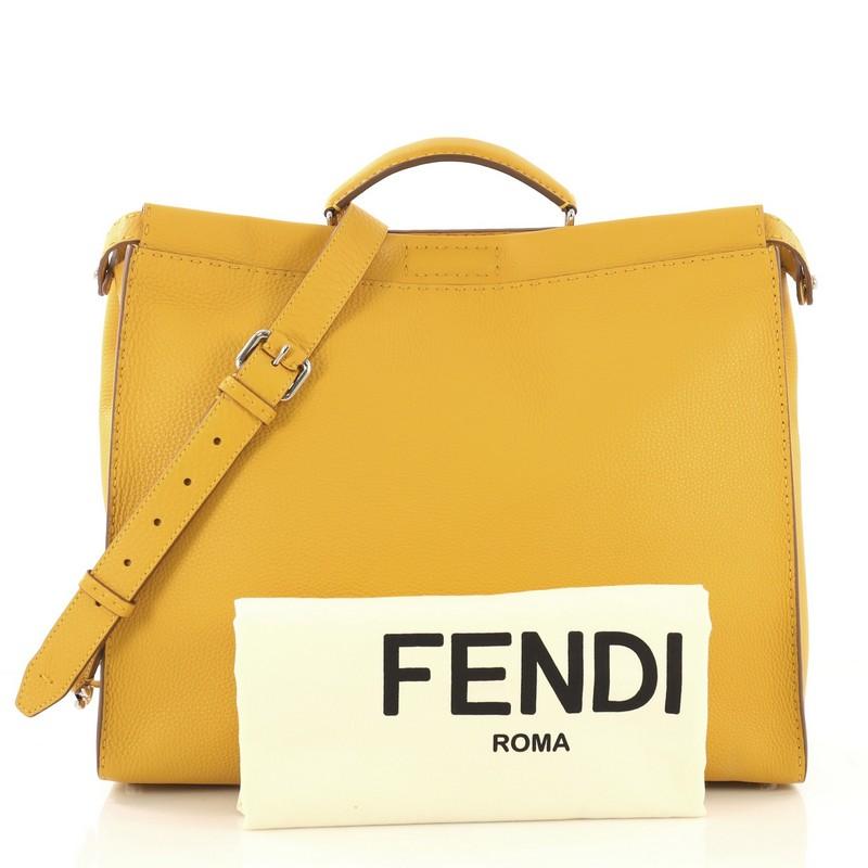 This Fendi Selleria Peekaboo Bag Leather XL, crafted from yellow leather, features short leather top handle and silver-tone hardware. Its two compartments with press-lock and zip closures open to a black microfiber interior with side zip pocket.