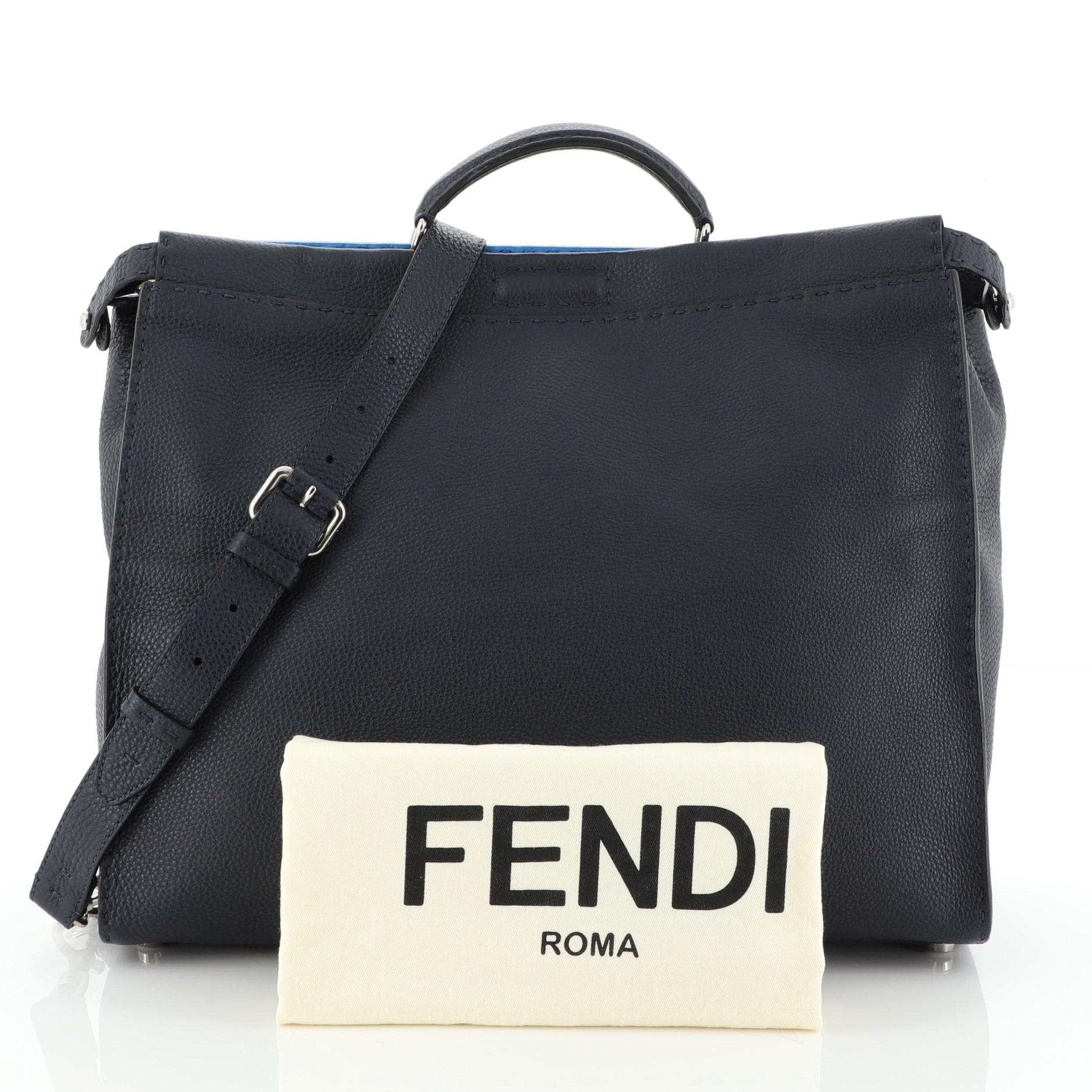 This Fendi Selleria Peekaboo Bag Leather XL, crafted from blue leather, features short leather top handle and silver-tone hardware. Its two compartments with press-lock and zip closures open to a black and blue microfiber interior with side zip