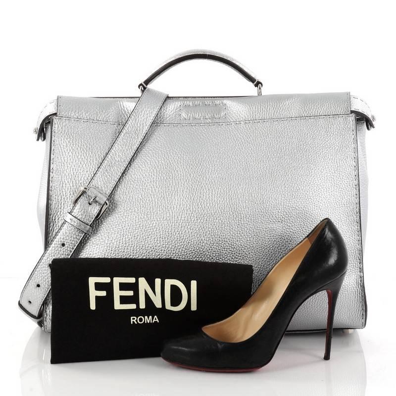 This authentic Fendi Selleria Peekaboo Handbag Leather Large is one of Fendi's best-known designs exuding a luxurious yet minimalist appearance. Crafted in silver leather, this versatile and stylish satchel features a flat leather top handle,