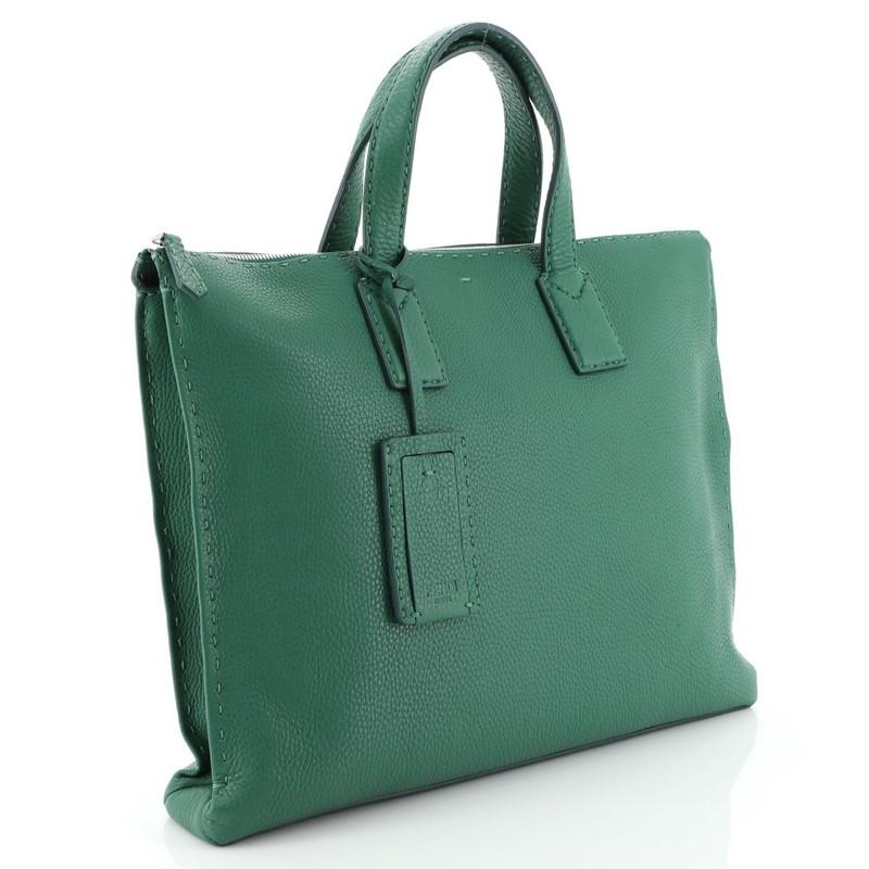 This Fendi Selleria Zip Tote Leather Large, crafted in green leather, features dual leather handles, and silver-tone hardware. Its zip closure opens to a black fabric interior. 

Condition: Good. Wear and darkening on base corners, small marks and