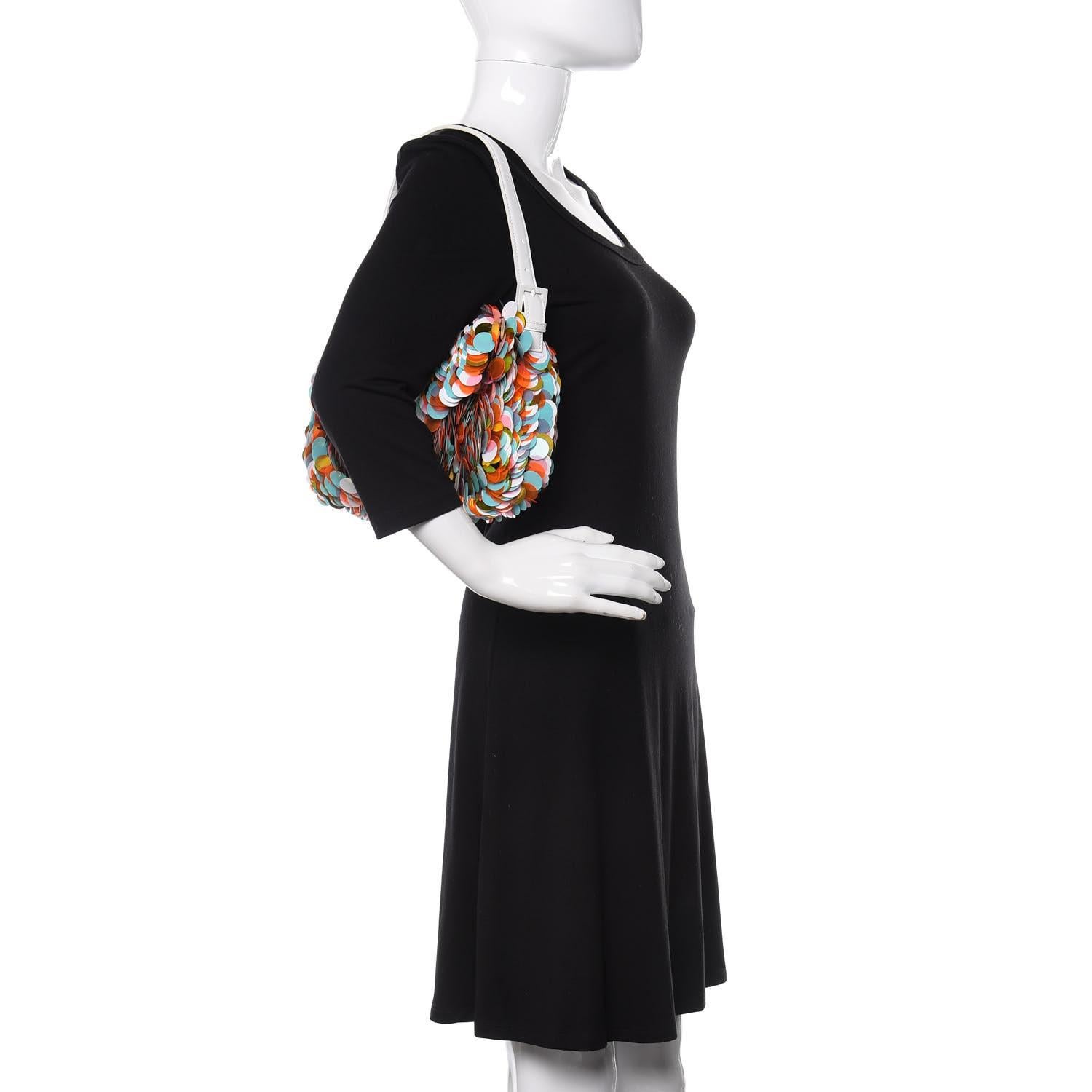 This baguette is made of large multicolor paillettes. The bag features a white leather shoulder strap with white hardware. The flap opens to a black fabric interior with a patch pocket. Cuoio Lucido.

Size: Medium
Color: Multicoloured
Material: