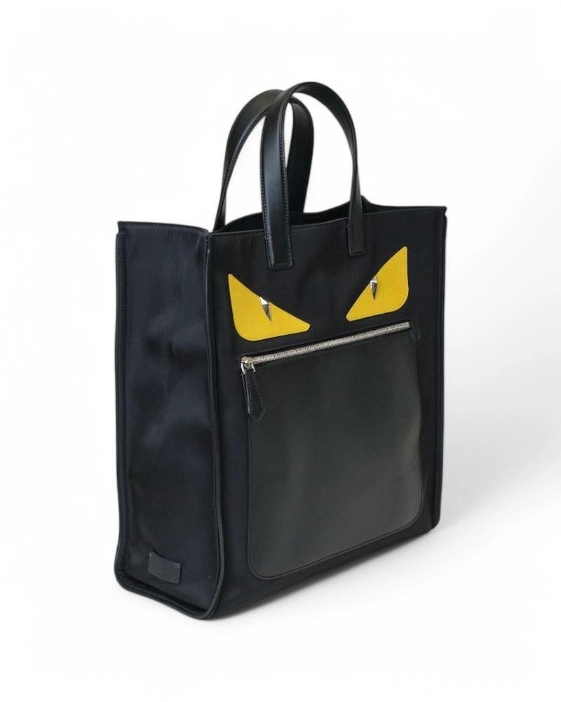 Fendi signature bag, Shopper Monster model in size Large, made of black fabric with leather trim and silver hardware. It has no closure, internally lined with tone-on-tone logo fabric with convenient pocket, the bag is very roomy. Equipped with