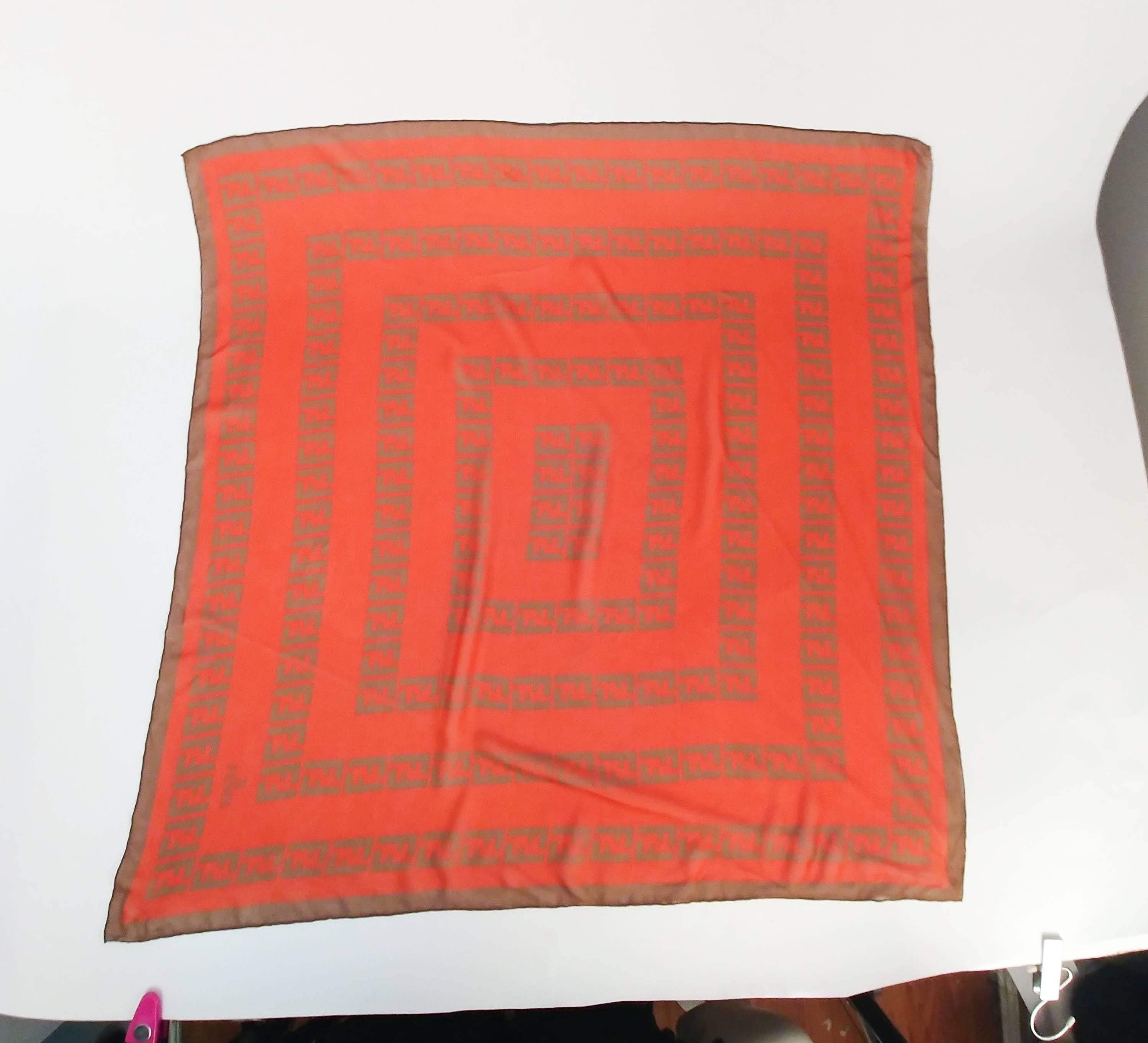 Fendi Silk Chiffon Printed Logo Scarf. Orange and brown printed chiffon scarf. Hand-rolled edges. 