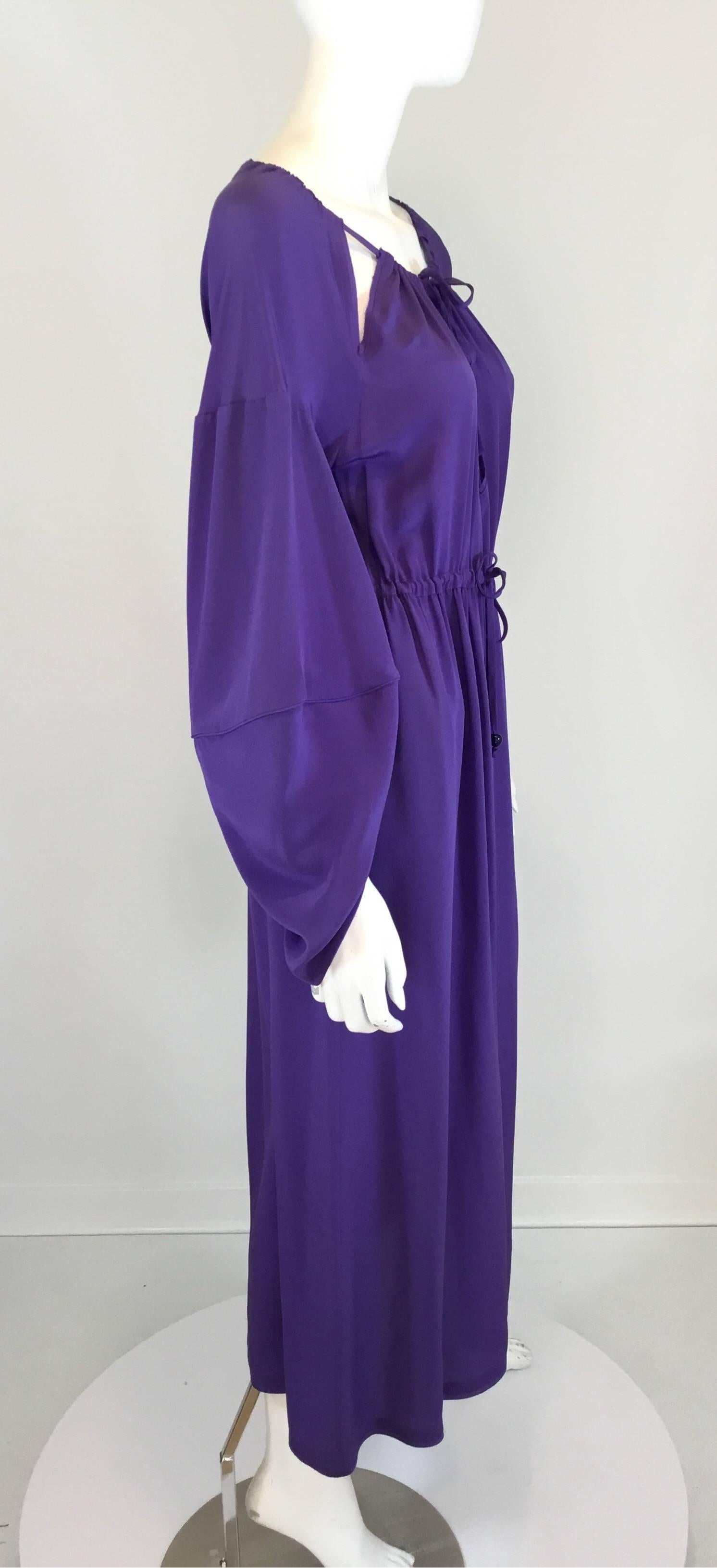 Fendi midi dress featured in purple and of 100% silk with a keyhole neckline detail, silk string tie closure at the neck waist, and butterfly sleeves. Dress is labeled a size 38, made in Italy.

bust 40'', waist 36'', hips 46'', length (center to