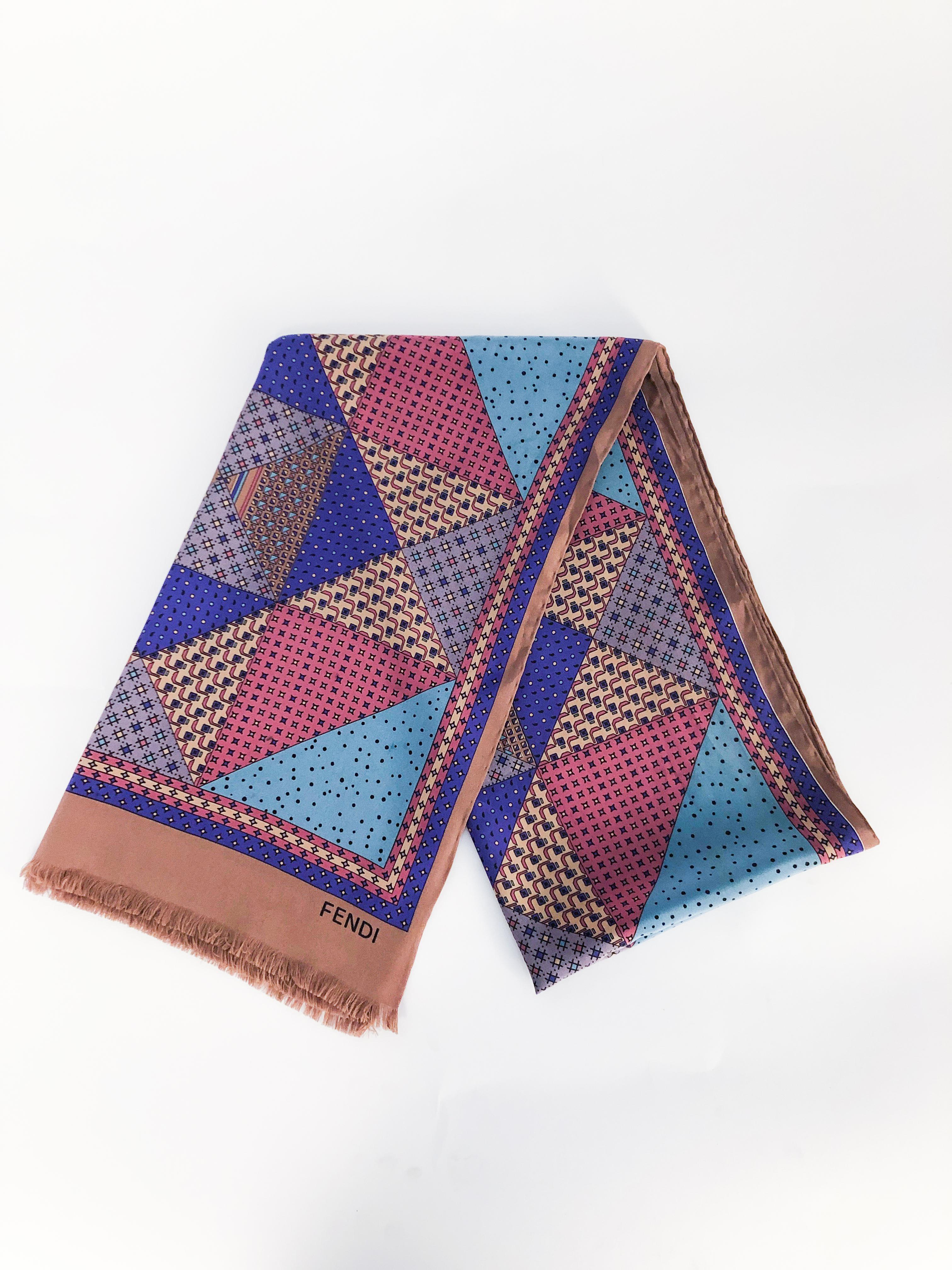 Fendi silk scarf with geometric print (featuring lilac, coral, violet, tan, and brown) and hand rolled edges. 