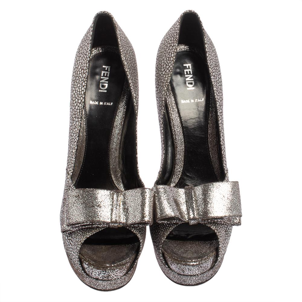 These exquisite pumps from Fendi are worth splurging on! Crafted from brocade fabric and textured leather, these silver Deco pumps flaunt peep toes with trendy bows on the uppers, and the 14 cm heels supported by platforms, are sure to lend your