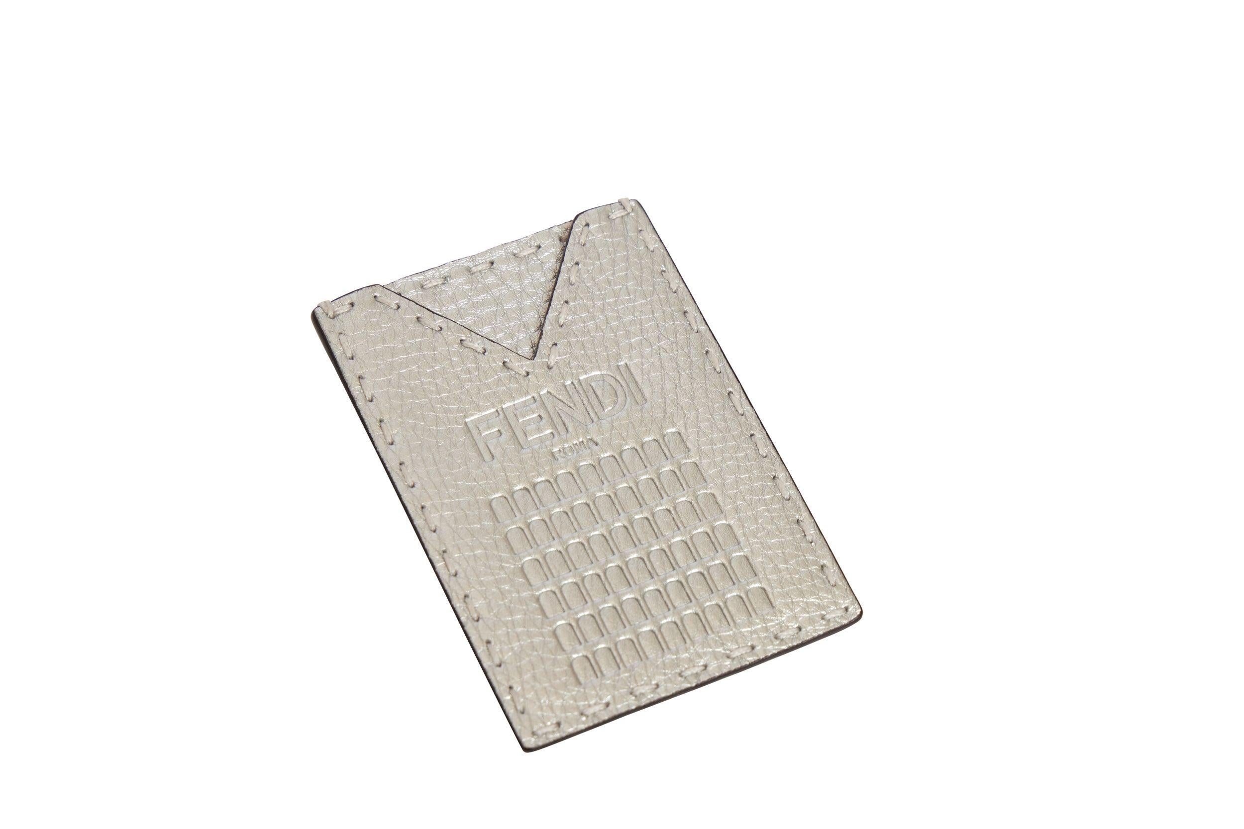Fendi Roma silver leather embossed card holder. The piece is brand new and comes with the booklet, card and dust cover.
