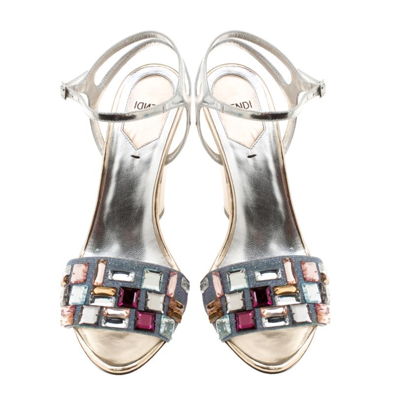 The front glitter fabric strap decked with crystals, the insert between the heel and shank and the silver coating adds the element of style to this Fendi pair. They are leather made and they feature ankle straps and 11 cm heels.

Includes: The