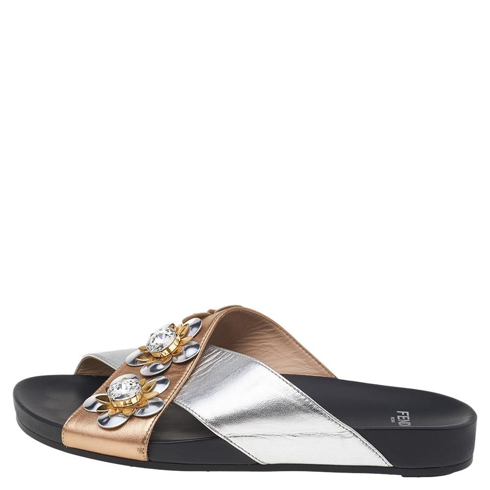 These slides from Fendi are trendy and chic, and a must-have in your wardrobe. They've been crafted from leather and detailed with flower motifs accented with crystals on the crisscross straps. These silver & gold flats are highly comfy and stylish