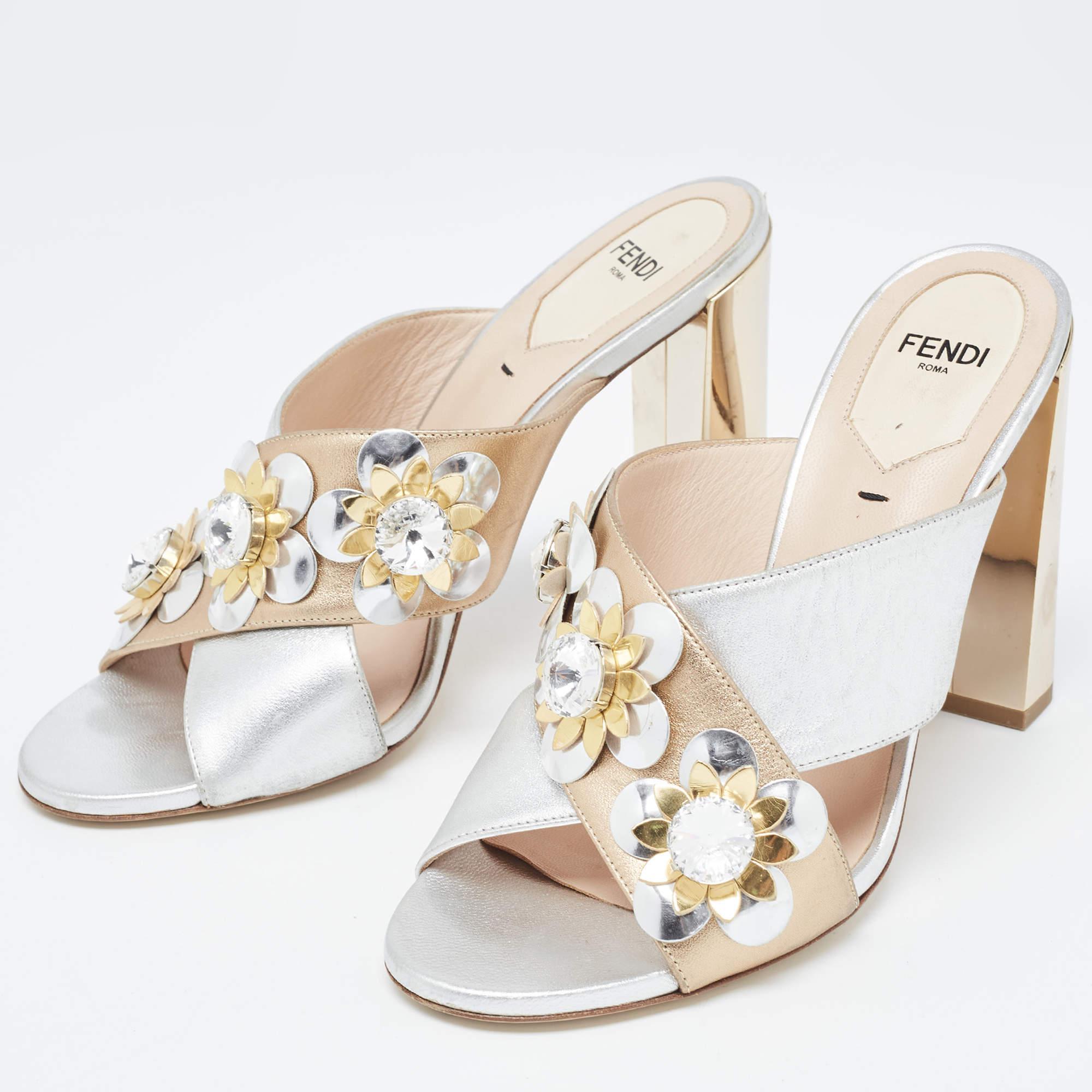 The eye-catching flower motifs on the criss-cross strap make these Fendi sandals desirable and graceful. Created from leather, they exhibit a slip-on fitting, 11cm heels, and silver-tone hardware.