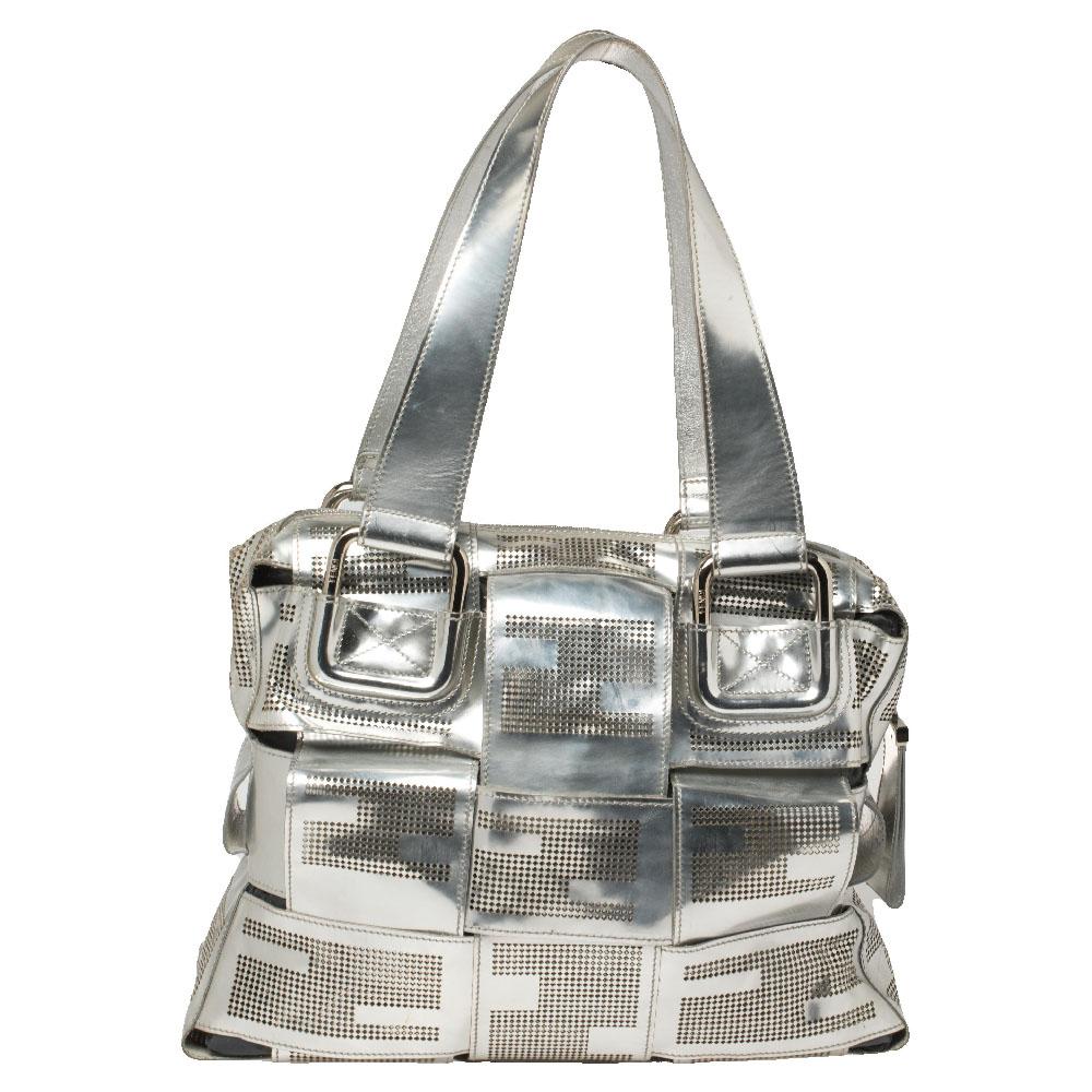 If you're looking for a unique designer bag, Fendi has just what you want! The Crossword bag by Fendi is woven with straps of silver leather into a practical size. It is held by two handles, lined with nylon, and enhanced with perforated