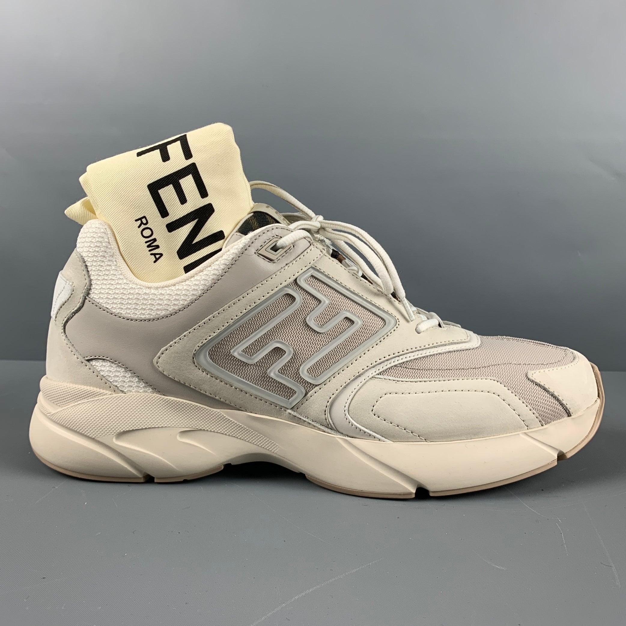 FENDI sneakers comes in a grey and white leather featuring a Fendi monogram, mesh accents, and a lace up closure. Made in Italy. Includes dust bag. Very Good Pre-Owned Condition. Moderate wear throughout. 

Marked:   7E1555 11Outsole: 11.75 inches 