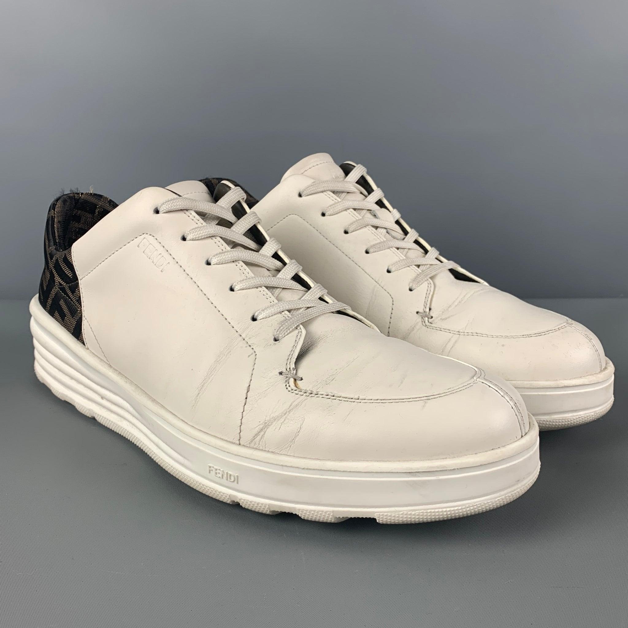 FENDI sneakers comes in a white leather with a brown logo trim featuring a split toe and a lace up closure. Made in Italy. Includes dust bag.
Good
Pre-Owned Condition. Moderate wear throughout.  

Marked:  
Size not visible. Outsole: 13 inches  x