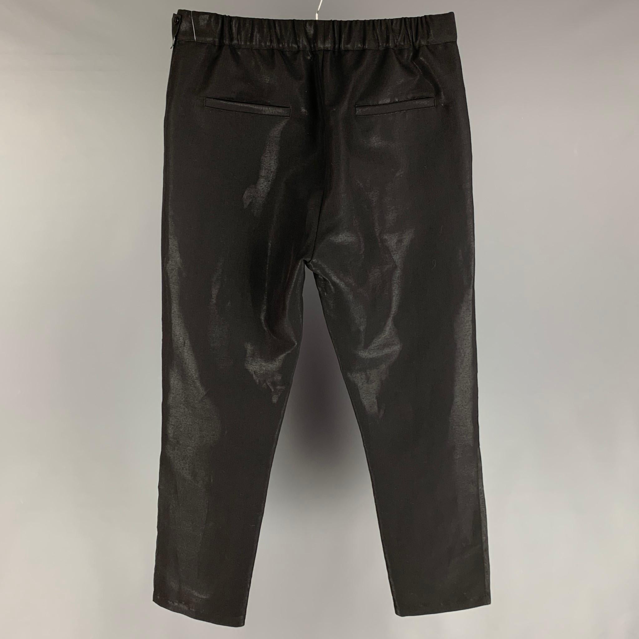 FENDI pants comes in a black virgin wool / polyester featuring a cargo style, sheer patch pockets, drawstring, elastic waistband, and a zip fly closure. Made in Italy. 

Excellent Pre-Owned Condition.
Marked: 5

Measurements:

Waist: 34 in.
Rise: 14