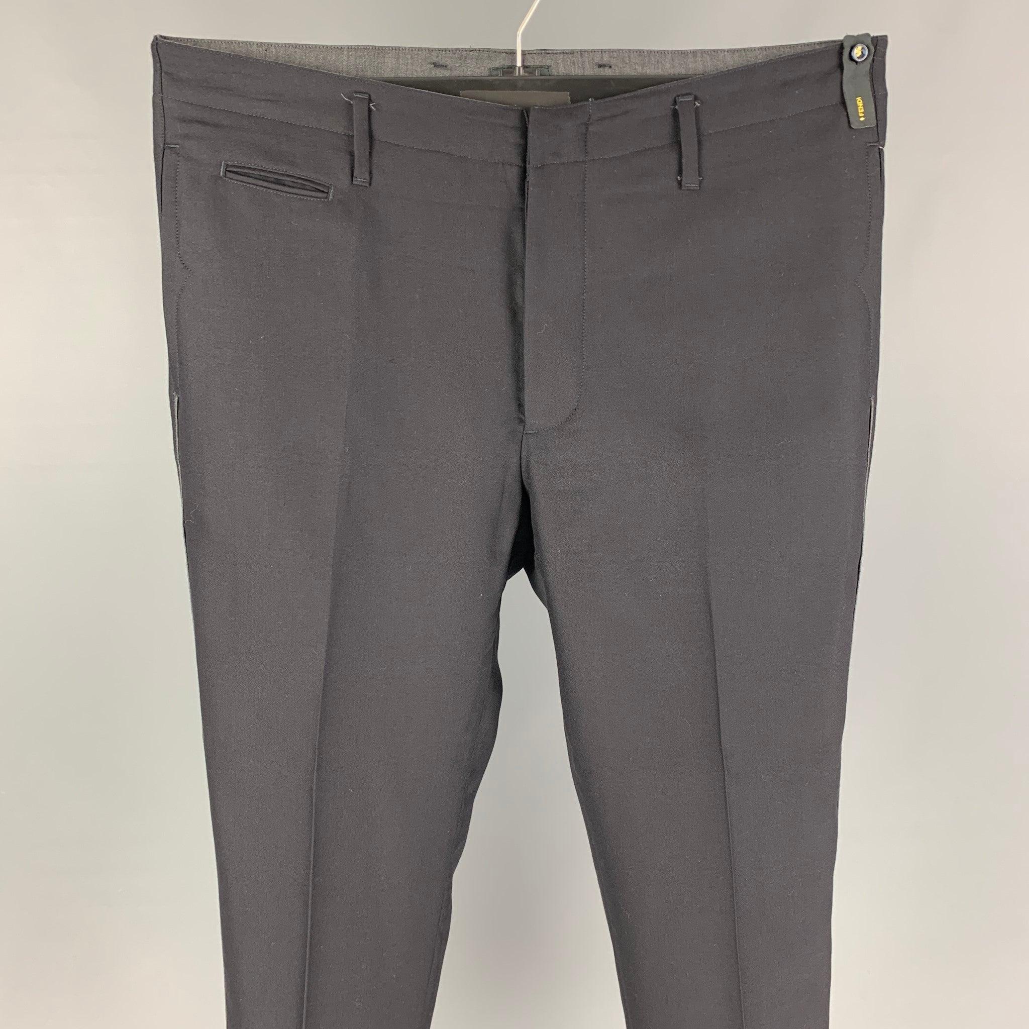 FENDI dress pants comes in a black virgin wool featuring a flat front, slim fit, side stripe detail, front tab, and a button fly closure. Made in Italy.
 Excellent
 Pre-Owned Condition. 
 

 Marked:  50 
 

 Measurements: 
  Waist: 34 inches Rise:
