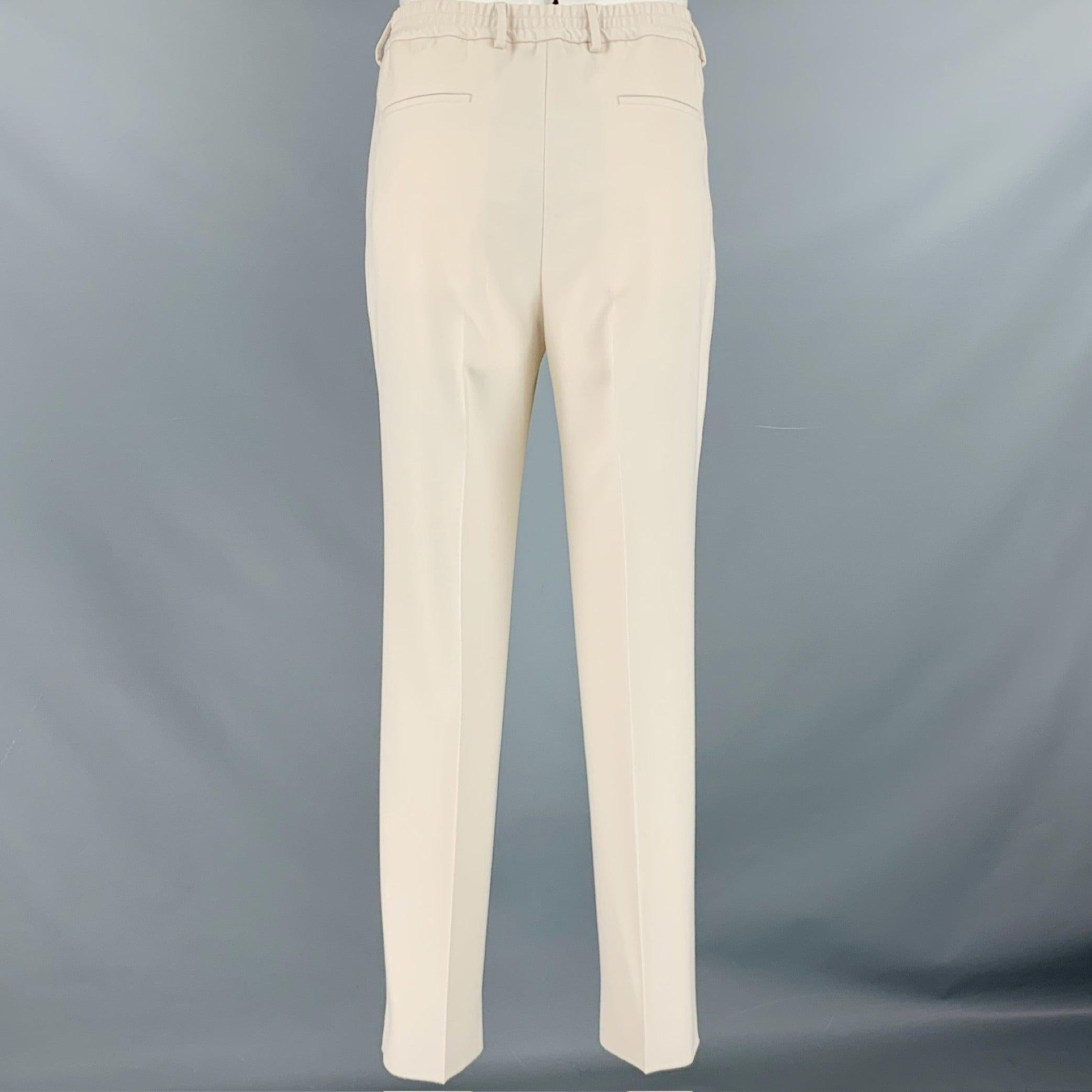 FENDI dress pants
in a beige polyester wool blend fabric featuring a pleated style, elastic waistband, and zip fly closure. Made in Italy.Excellent Pre-Owned Condition. 

Marked:   52 

Measurements: 
  Waist: 36 inches Rise: 10.5 inches Inseam: 33