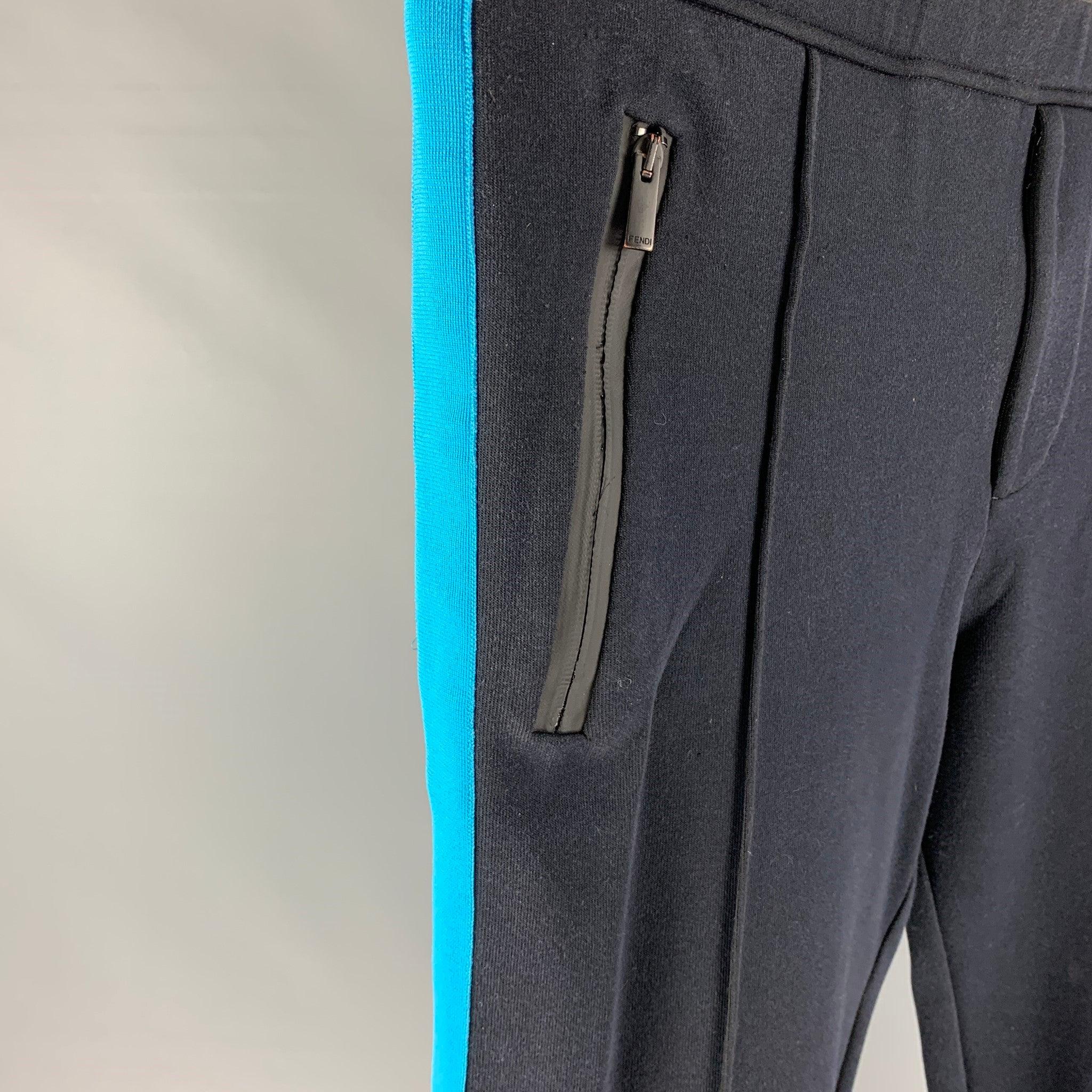 FENDI sweatpants comes in a navy cotton blend with a blue stripe detail featuring a front pleat, zipper pockets, elastic waist, and a zip fly closure. Made in Italy.
Very Good
Pre-Owned Condition. 

Marked:   52 

Measurements: 
  Waist: 36 inches 