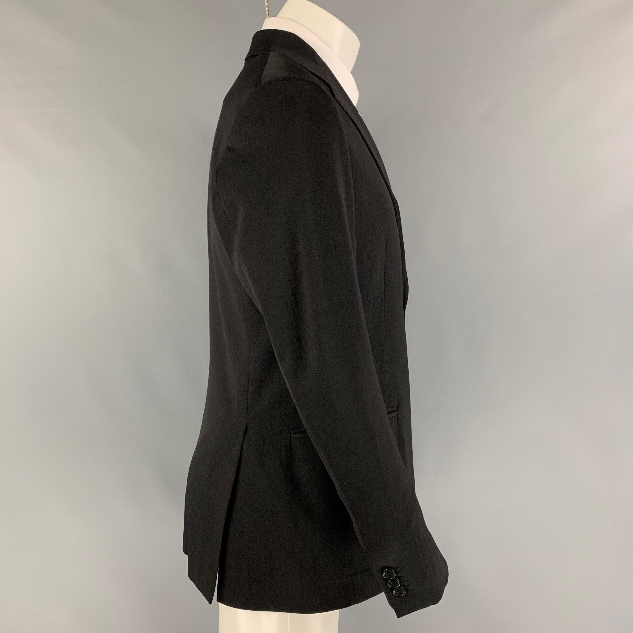 FENDI sport coat comes in a black wool with a full liner featuring a notch lapel, slit pockets, double back vent, and a double button closure. Made in Italy.
Very Good
Pre-Owned Condition. 

Marked:   50 

Measurements: 
 
Shoulder: 17.5 inches 