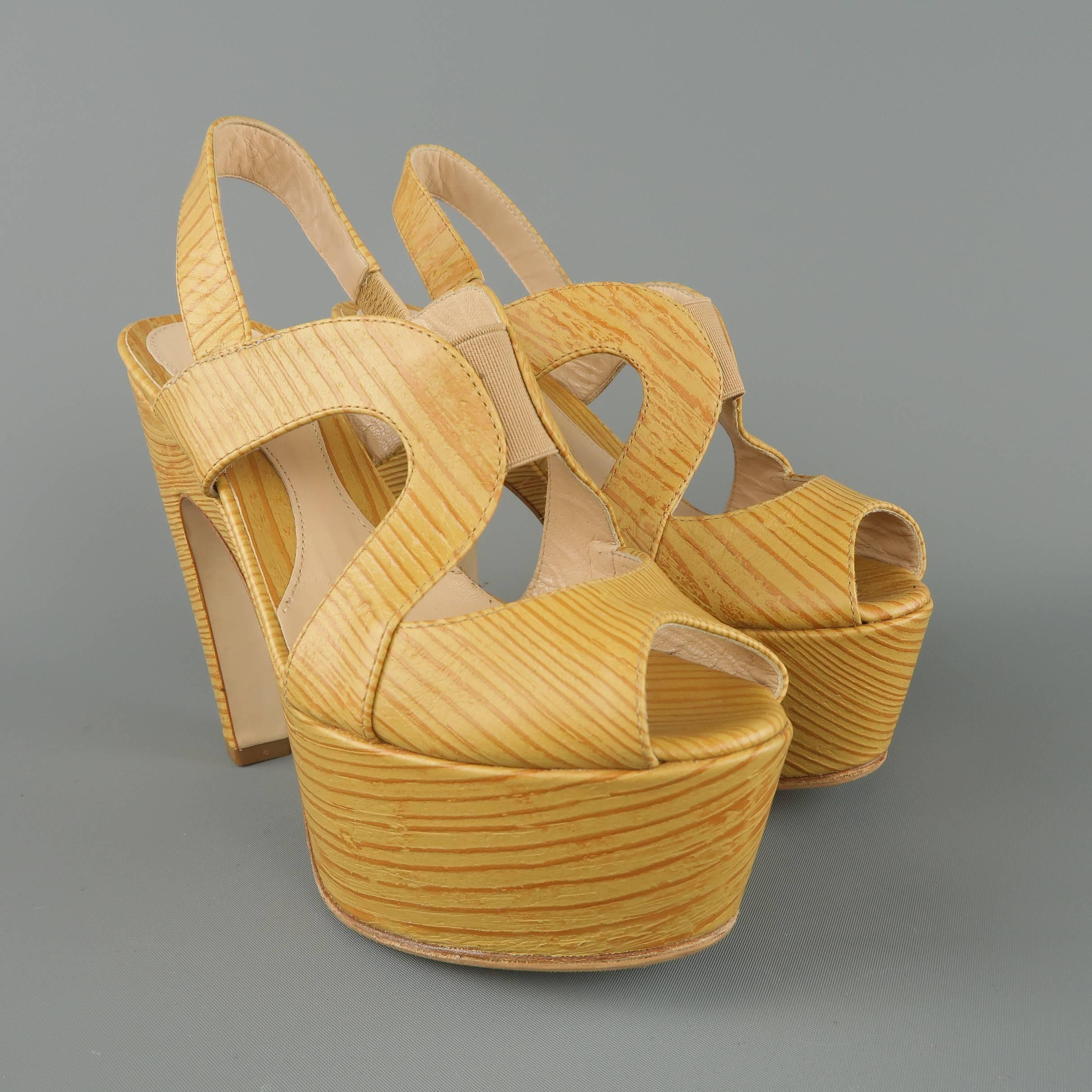 FENDI sandals come in a golden beige leather embossed to look like wood and features a peep toe, curved straps, slingback, and chunky curved heel with platform. Made in Italy.
 
Excellent Pre-Owned Condition.
Marked: IT 35.5
 
Measurements:
 
Heel:
