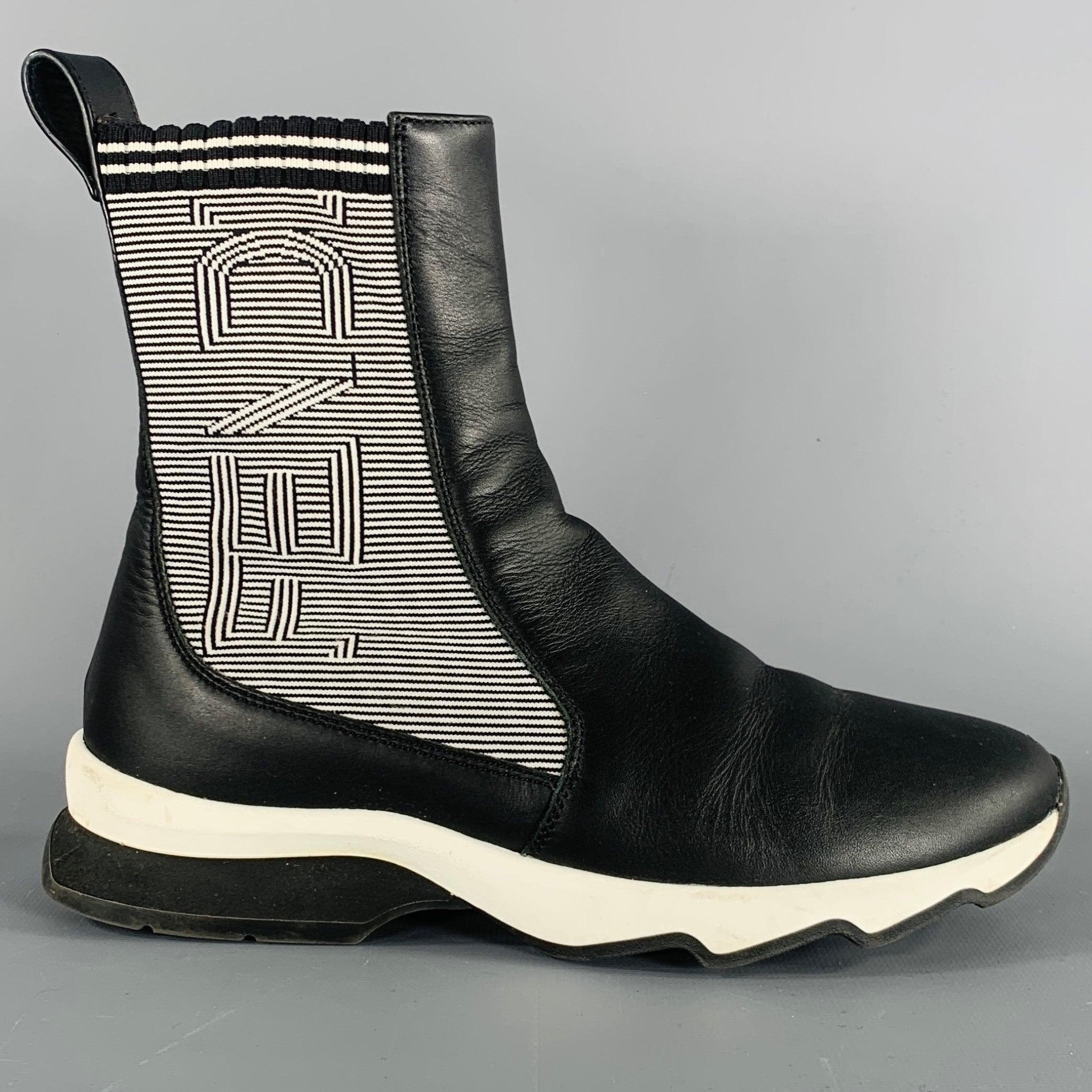 FENDI boots
in a black leather featuring a sock style, knit panels with black and white FENDI logo, and rubber sole. Very Good Pre-Owned Condition. Some creasing. 

Marked:   8E 663 36 

Measurements: 
  Length: 9.75 inches Width: 3.75 inches