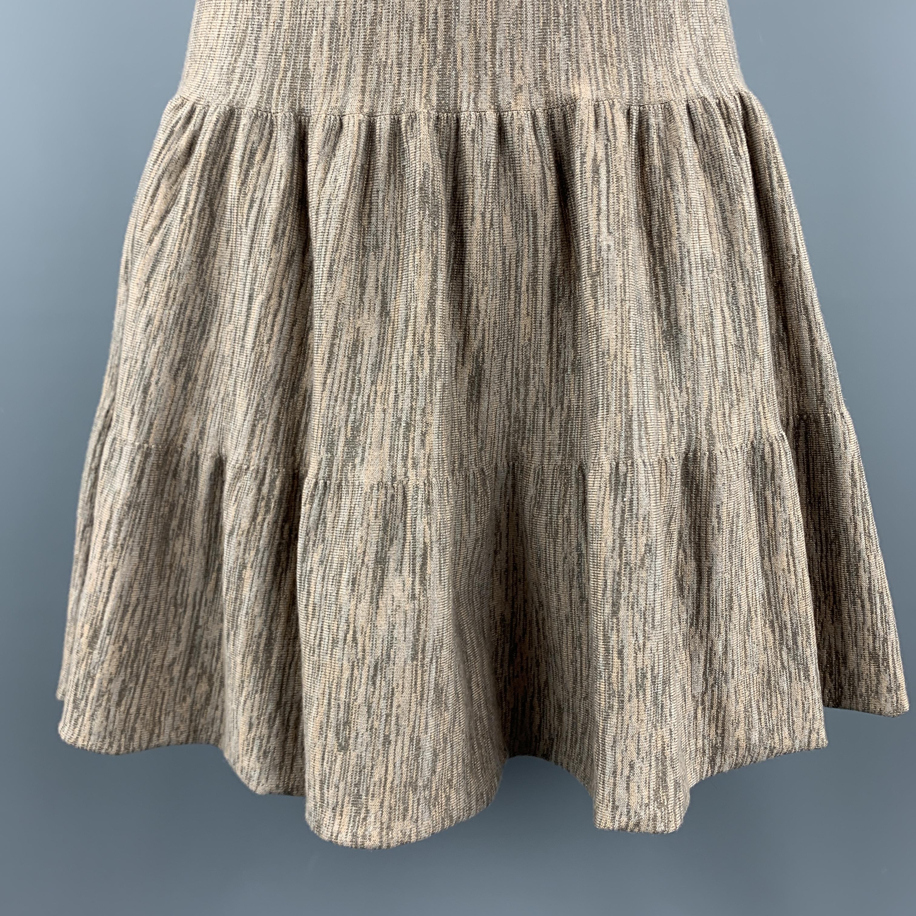 FENDI A line skirt comes in taupe and beige heathered wool knit with tiered ruffles. Made in Italy.

Excellent Pre-Owned Condition.
Marked: IT 40

Measurements:

Waist: 25 in.
Hip: 42 in.
Length: 20 in.