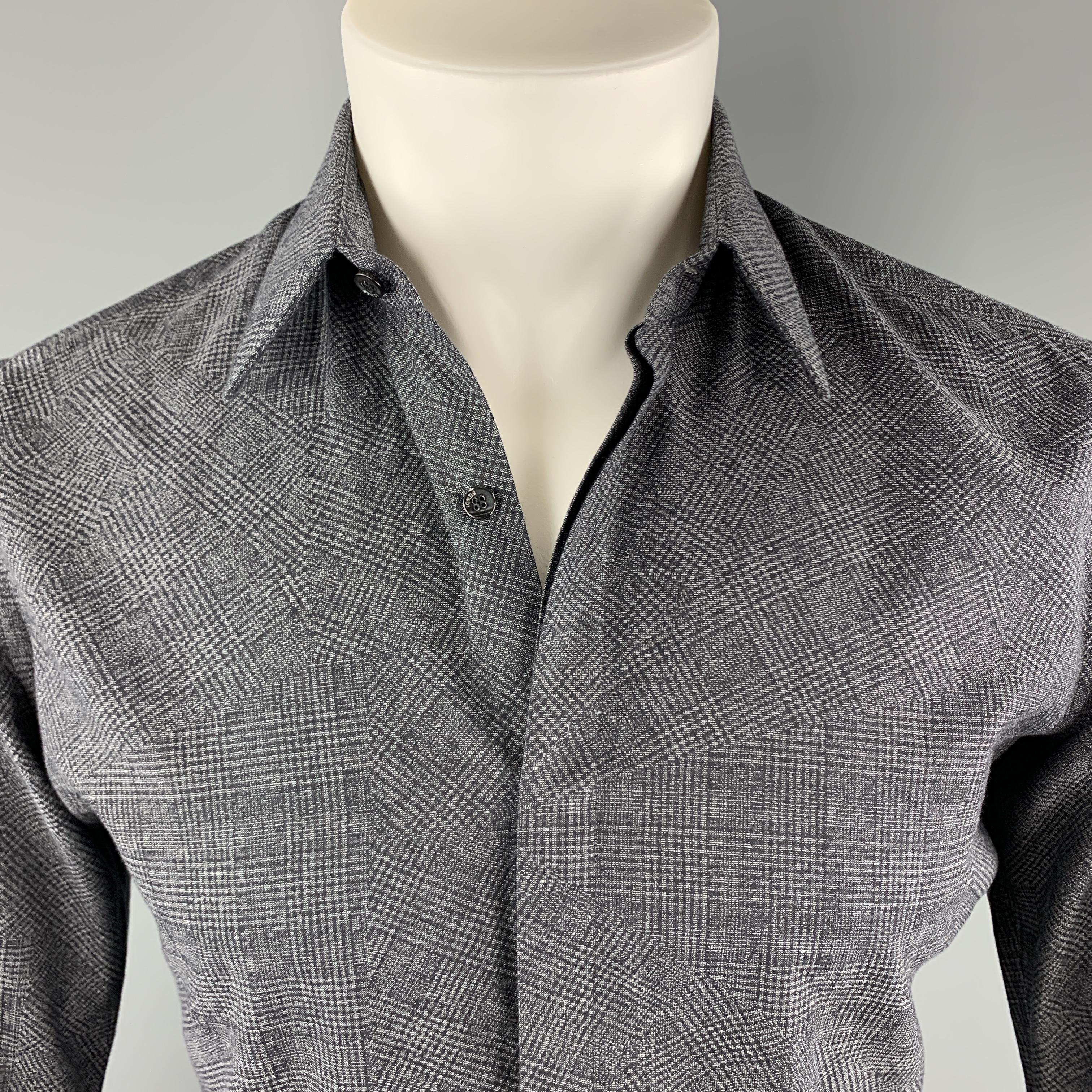 FENDI shirt comes in black and gray abstract plaid cotton with a hidden placket button front. Made in Italy.

Excellent Pre-Owned Condition.
Marked: 38

Measurements:

Shoulder: 16 in.
Chest: 41 in.
Sleeve: 22 in.
Length: 30 in.