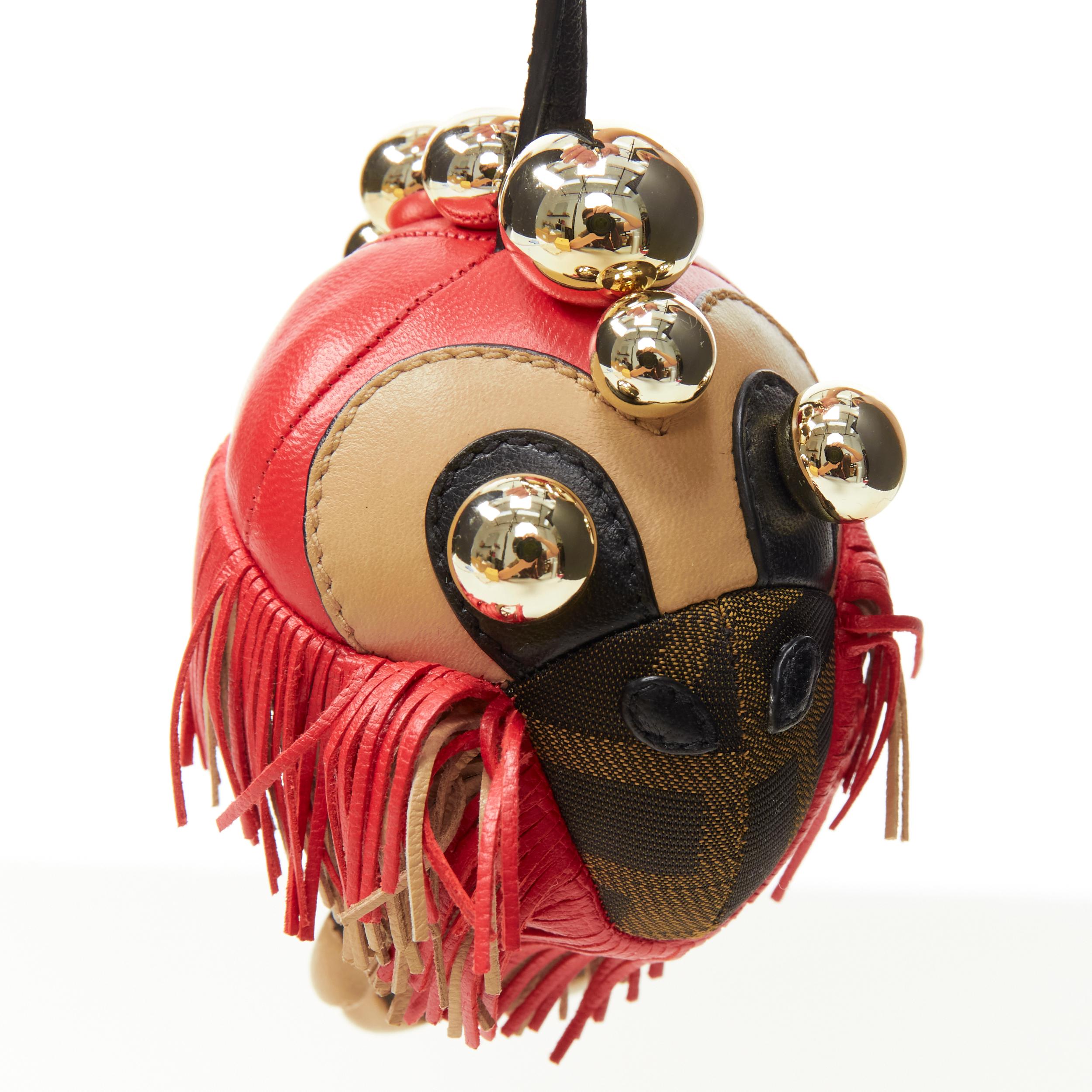FENDI Space Monkey Zucca FF monogram red fringe gold stud keyring bag charm 
Reference: ANWU/A00115 
Brand: Fendi 
Collection: Space Monkey 
Material: Canvas 
Color: Brown 
Pattern: Monogram 
Closure: Clasp 
Extra Detail: Brown Zucca FF monogram