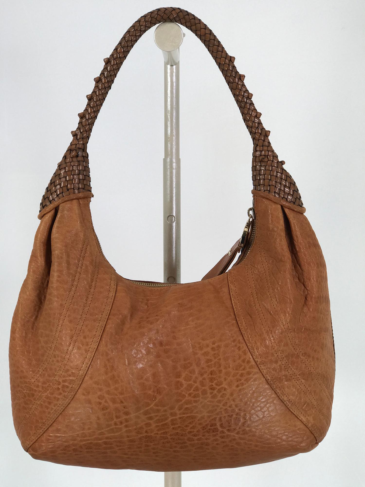 Fendi Spy Boho should bag in caramel leather, with Zucca lining. Braided Spy handle, the bag is a softly textured leather in a warm caramel shade, the bag has a braided welt cord seam running down the outside of the bag. Chunky gold brass zipper