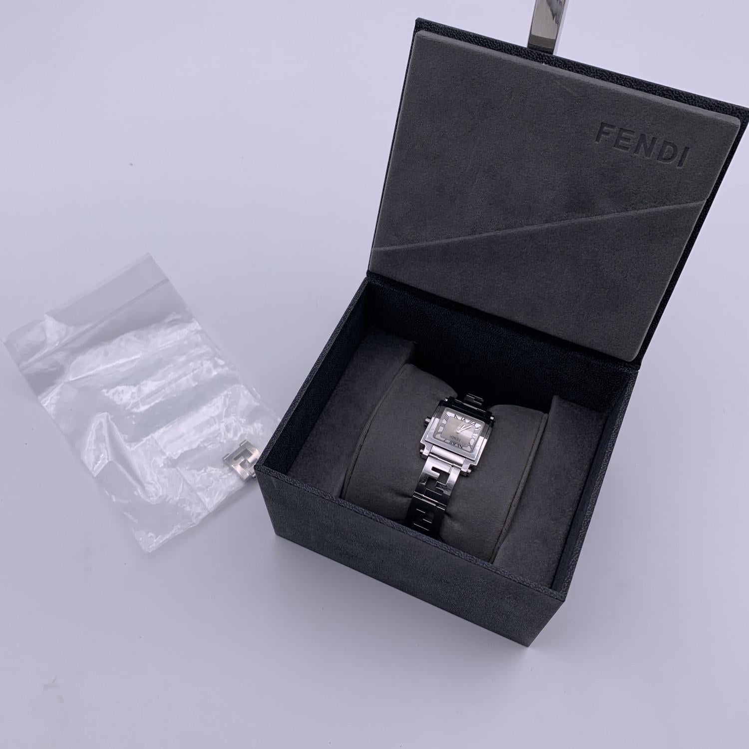 Fendi silver-tone stainless steel watch, Mod. 6000 L. Square stainless steel case. Silver dial with roman numbers and two hands. Sapphire crystal. Swiss Made Quartz movement. Fendi written on face. Silver-tone wrist strap with FF logos. Deployant
