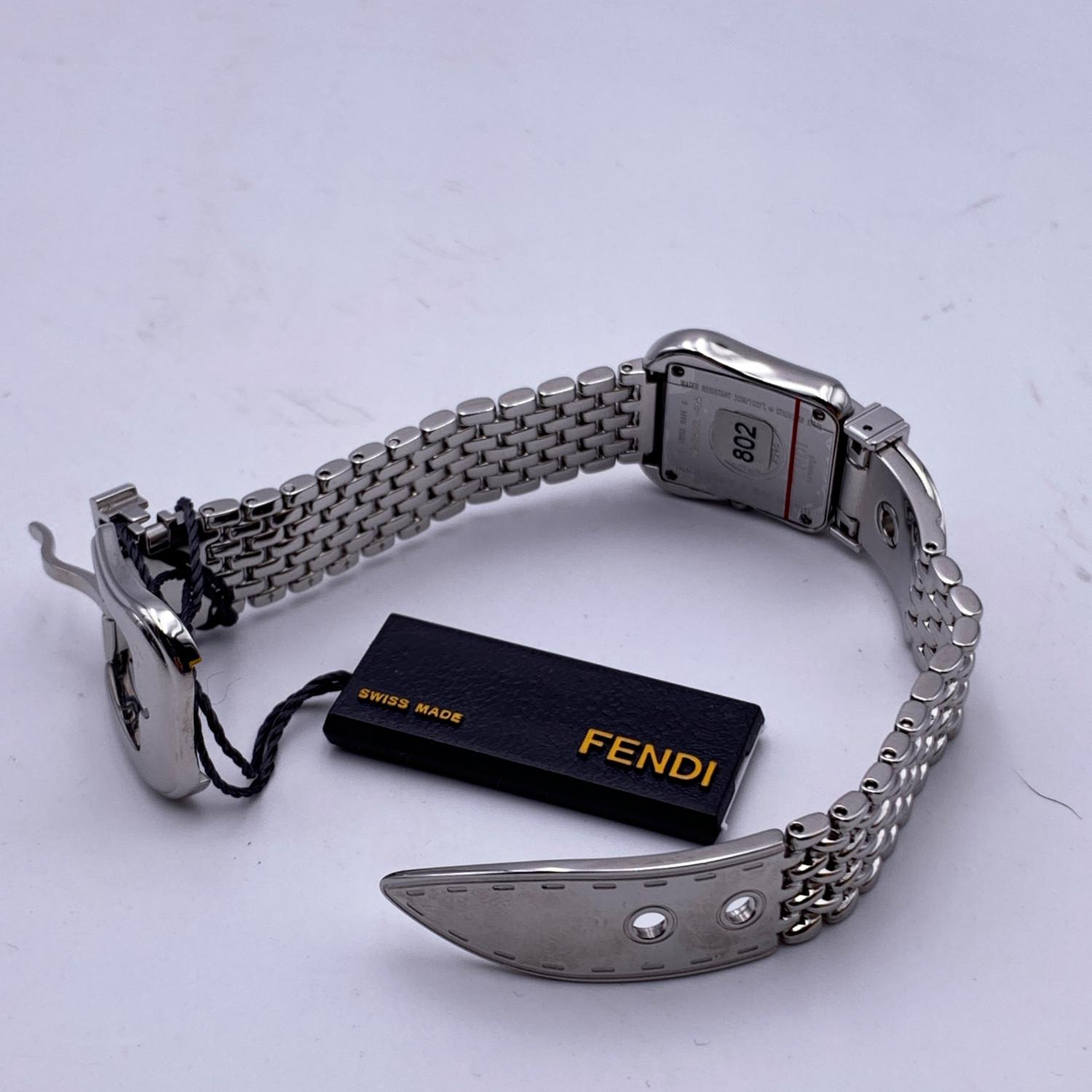 Beautiful Fendi 'B. Buckle' watch, Mod. 3800 L. Rectangle stainless steel case with buckle-shaped bezel. White dial with Roman numerals. Silver metal hands. Scratch resistant sapphire crystal. Swiss Made Quartz movement. Stainless steel wrist band.