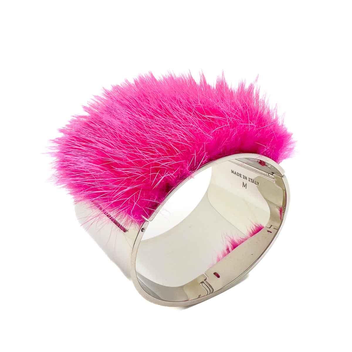 A striking Fendi Pink Cuff. A large contemporary style cuff with a dramatic twist of shocking pink fur to finish.

Vintage Condition: Very good without damage or noteworthy wear.
Materials: Rhodium plated metal, fur
Signed: Fendi
Fastening: Snap