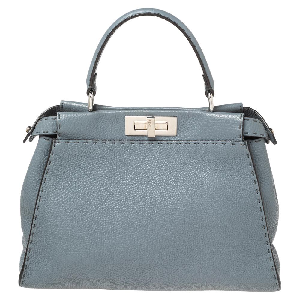 This Peekaboo bag from the House of Fendi is eternal, highly coveted, and impresses everyone with its shape, design, and beauty. This version comes meticulously crafted from stone blue Selleria leather, with a silver-toned logo-engraved lock on the