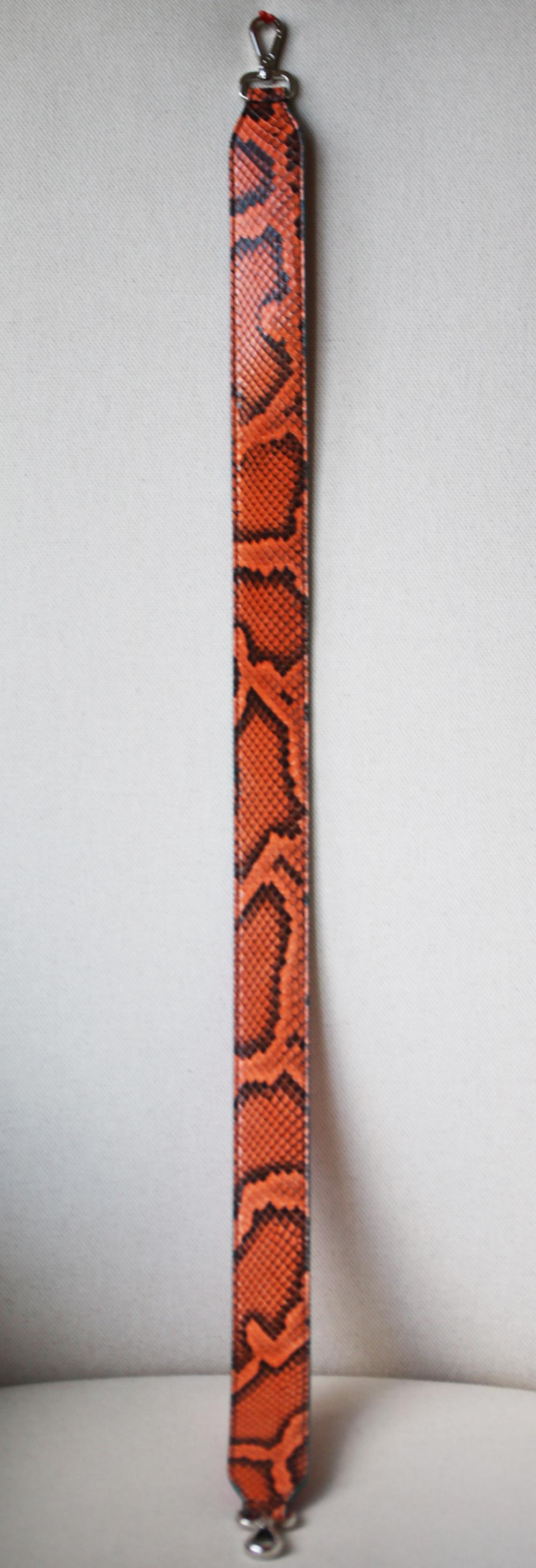 Fendi's bag strap is crafted from luxurious deep orange python and supple bright-pink leather. This thick style is finished with turquoise-blue trims and designed to attach to your favourite tote for hands-free wear. Orange python, bright-pink and