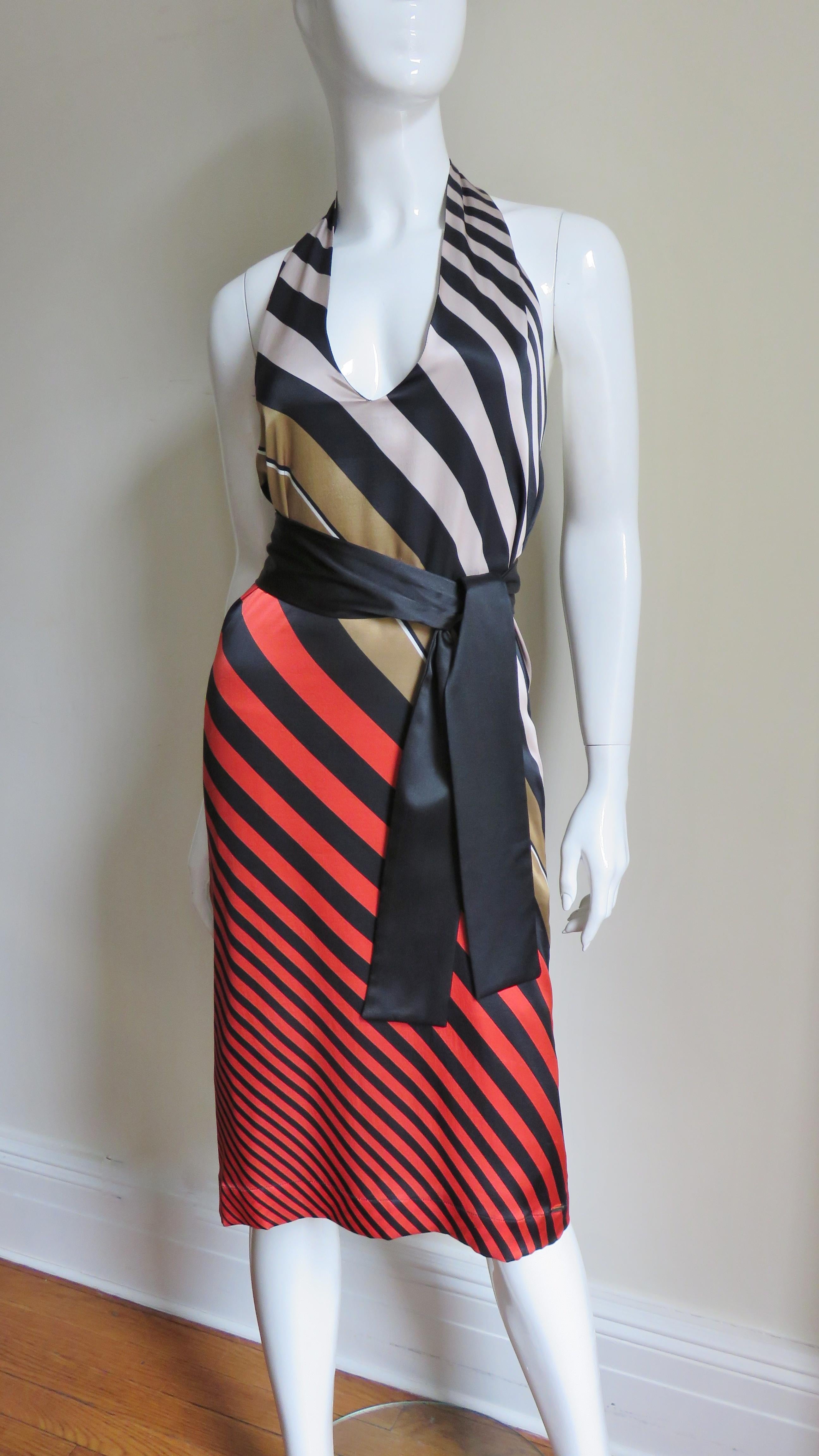 A great silk halter dress from Fendi in beige, grey, red and black angled stripes of varying widths.  It has a plunging neckline, low cut back and a black silk tie belt.  The skirt is straight and there are side seam pockets.  It is lined in black