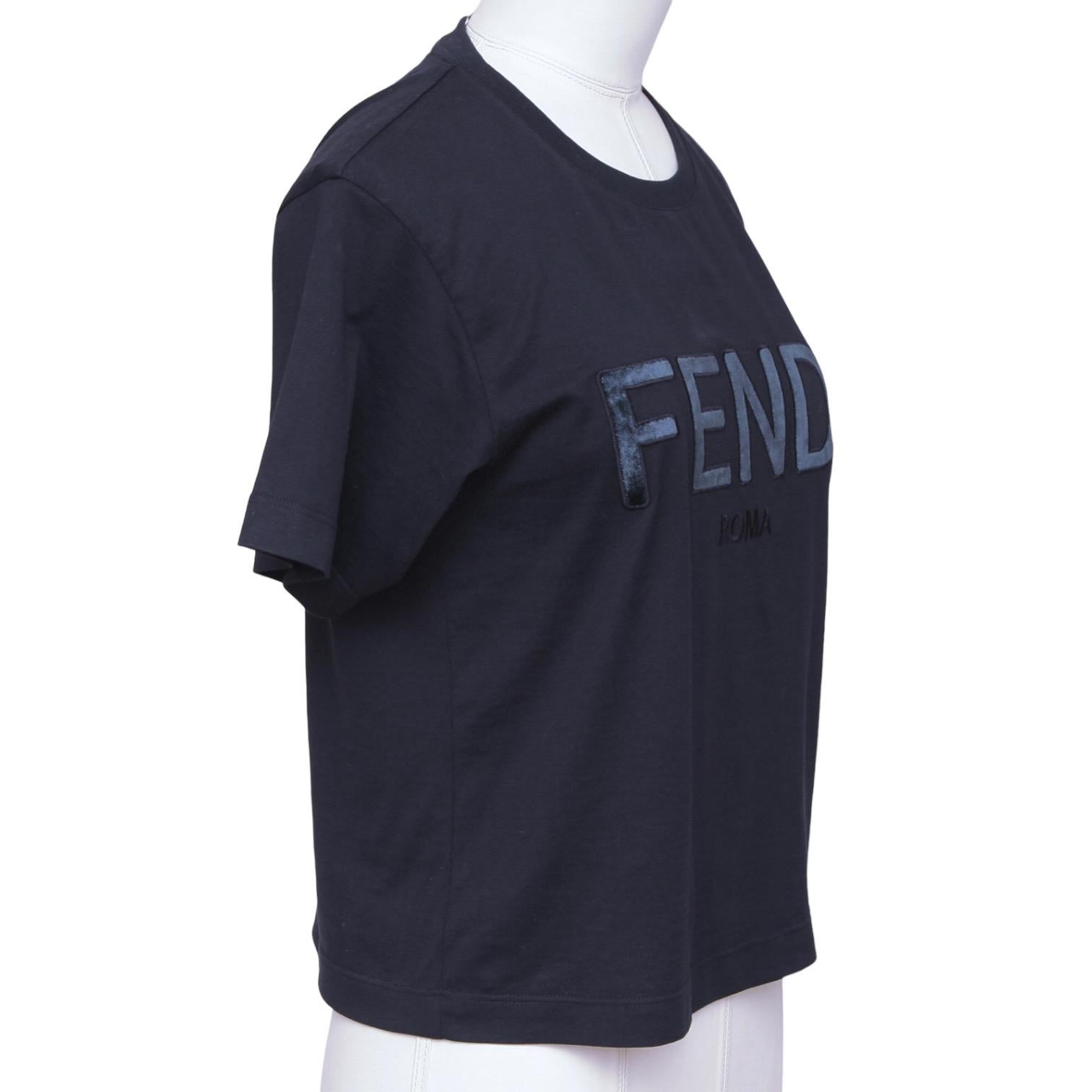 GUARANTEED AUTHENTIC FENDI CROPPED LOGO T-SHIRT

Design:
- Navy blue t-shirt.
- Crew neck.
- Short sleeve.
- Velvet logo.
- Slip on.

Size: XS

Material: 100% Cotton

Measurements (Approximate laid flat):
- Shoulder to Shoulder, 15.5