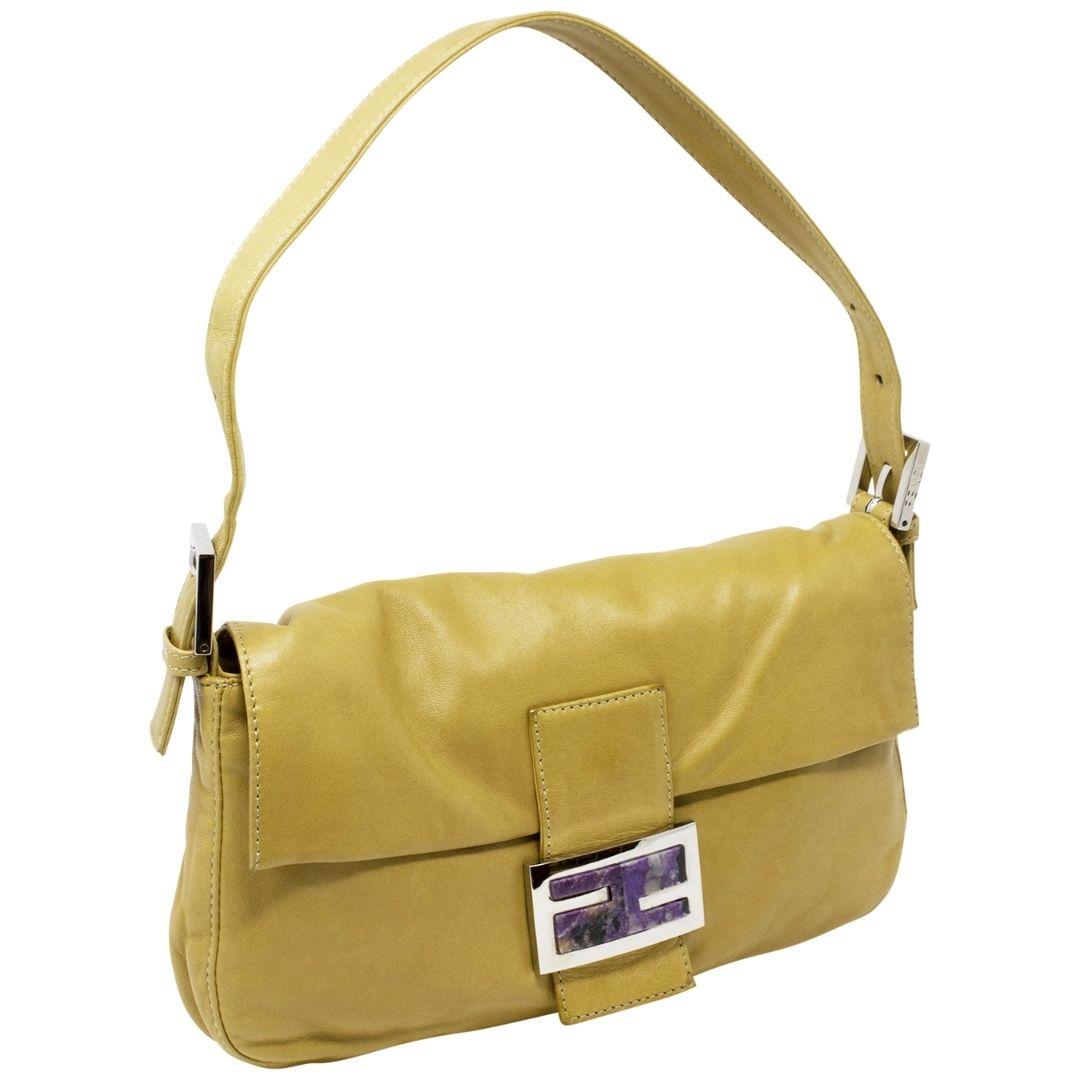 Timeless tan beauty with the perfect pop of purple marble crafted in lambskin leather, silver-tone hardware, an adjustable shoulder strap, with the iconic FF purple marble logo plate snap closure opening to a satin lining and one slip pocket. We