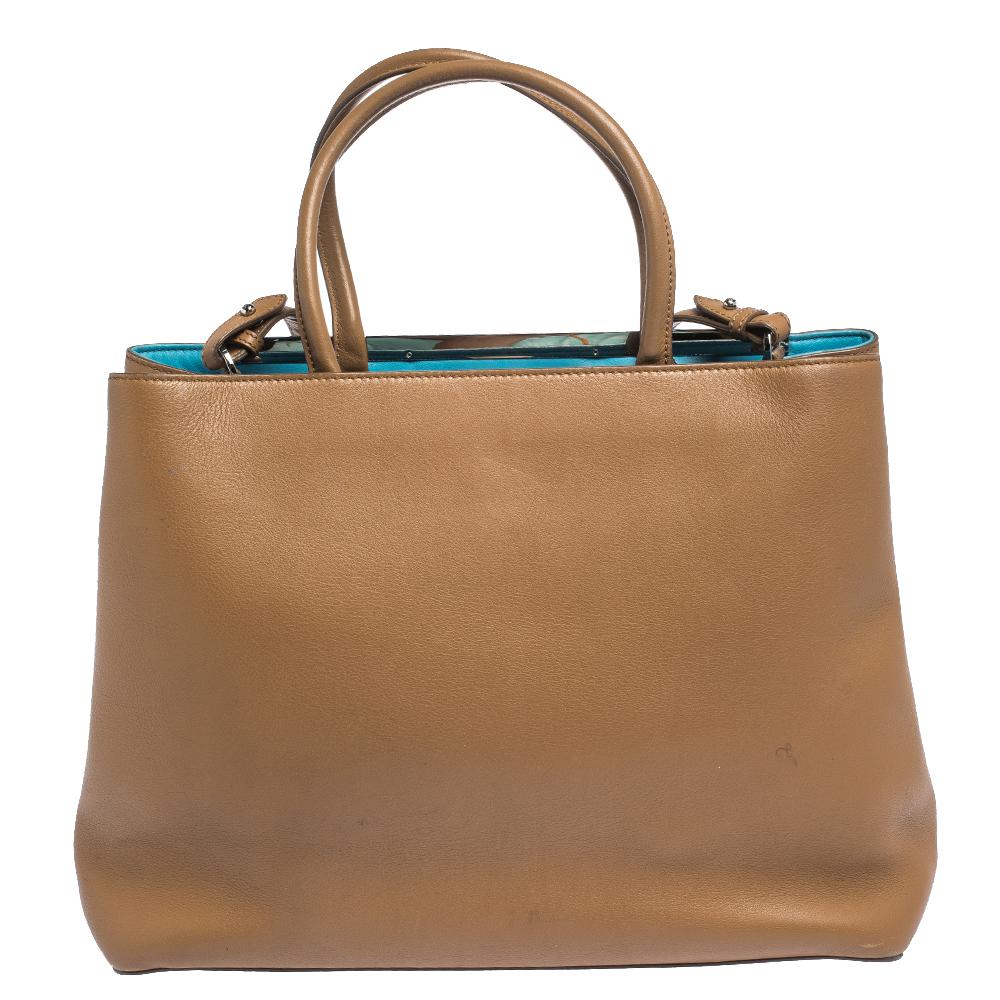 Fendi's 2Jours tote is one of the most iconic designs from the label and it still continues to receive the love of women around the world. Crafted from tan leather, the bag features double rolled handles. It is also equipped with a leather interior