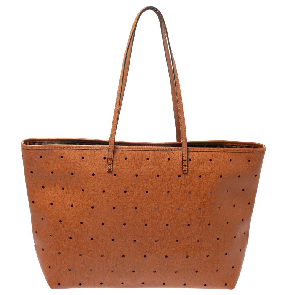 Functional and stylish, this tote is from Fendi! It has been crafted from perforated leather and designed in a tan shade. The bag is held by two handles and is equipped with a spacious interior capable of holding all your essentials.

Includes: