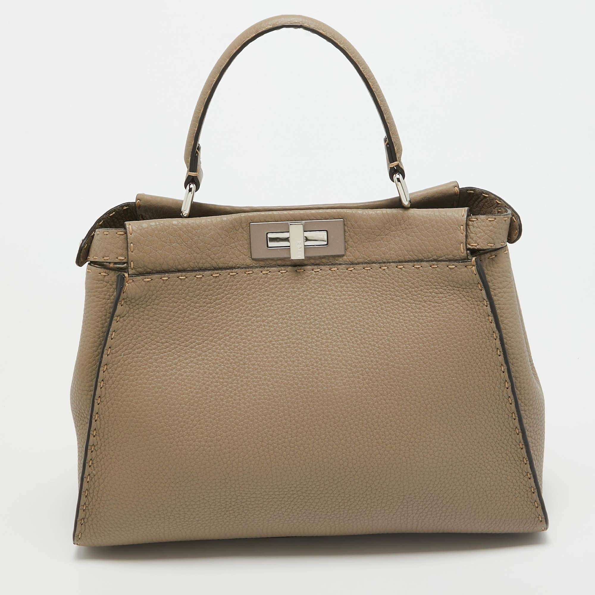 This exquisite Peekaboo from Fendi is highly coveted, and since its birth in 2009, it has swayed us with its shape, design, and beauty. This version comes meticulously crafted from leather, designed with a top handle for you to swing it, and