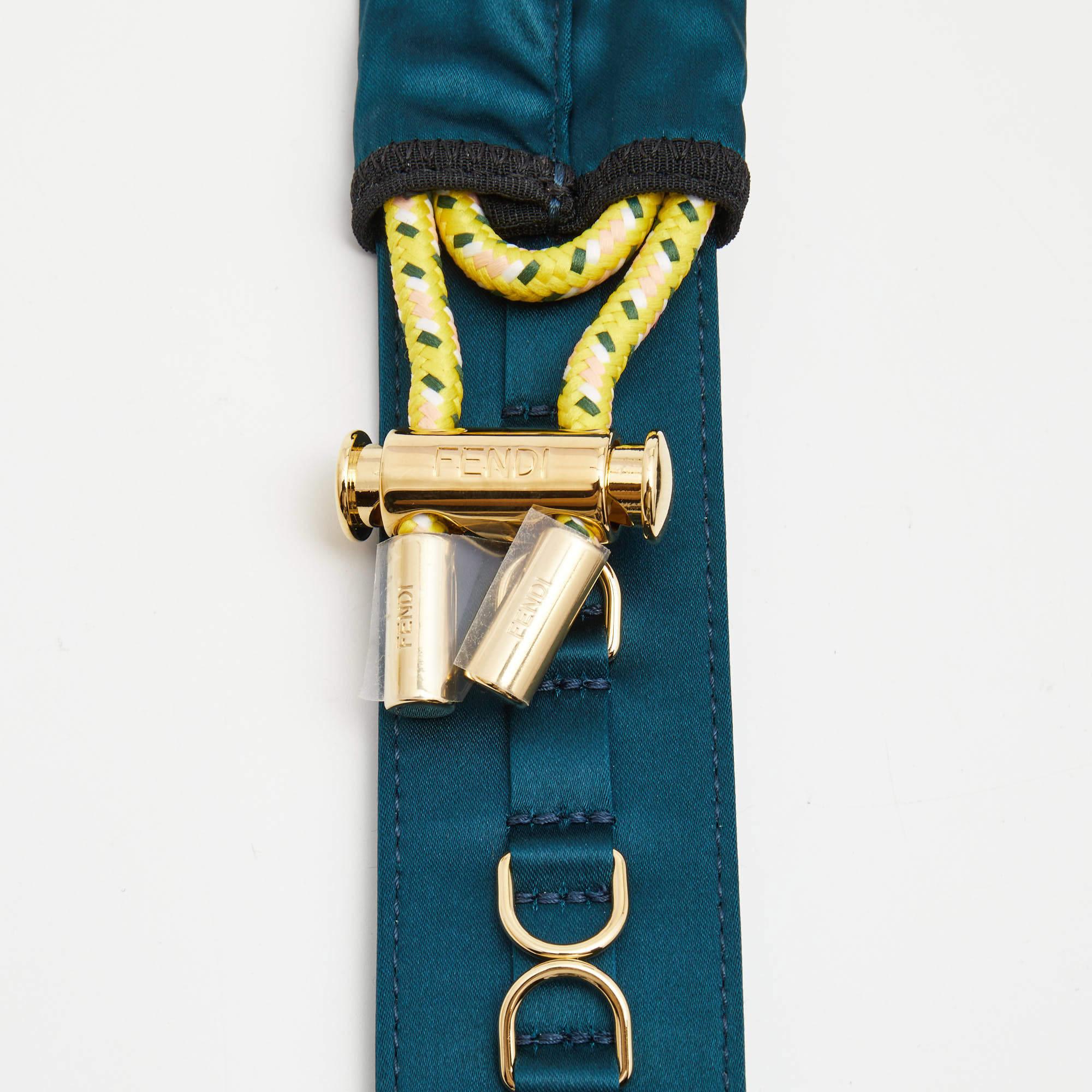 Enhance your style with the Fendi shoulder strap. Crafted with luxurious satin and adorned with a teal shade, this exquisite accessory adds a touch of elegance and sophistication to your handbag, making it a must-have for fashion