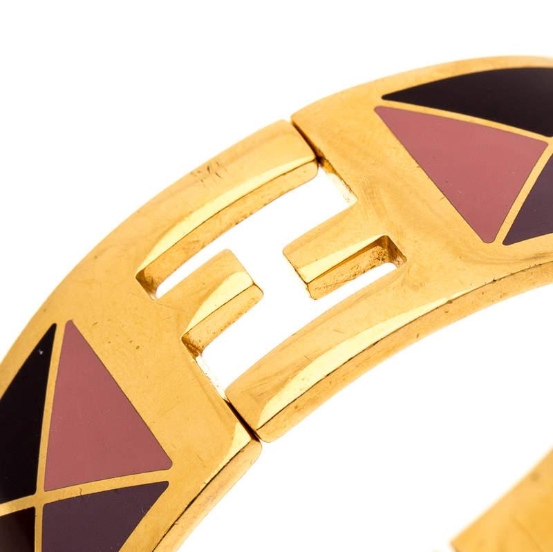 Fendi has always strived to bring out something new and different, and this bracelet is no exception. Exquisitely crafted from gold-tone metal, this stunning creation features multicolored, enamel-coated geometric pattern on the exterior and the