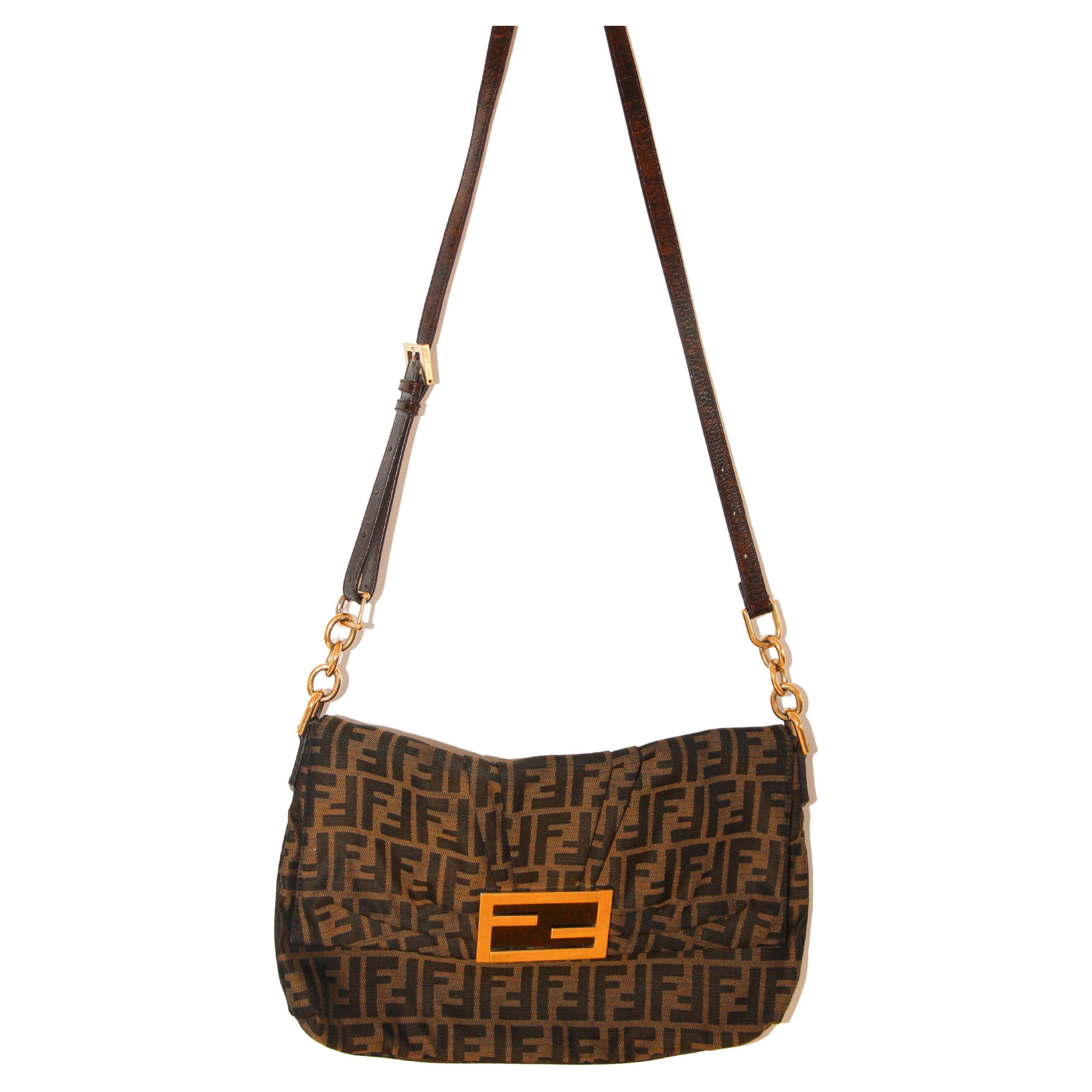 Fendi Tobacco Zucca Canvas and Patent Leather Mia Flap Handbag.
Complete a winning look with this Mia handbag from Fendi. Crafted from Zucca coated canvas and patent leather, the front comes with a striking gold-tone F and the top reveals a spacious