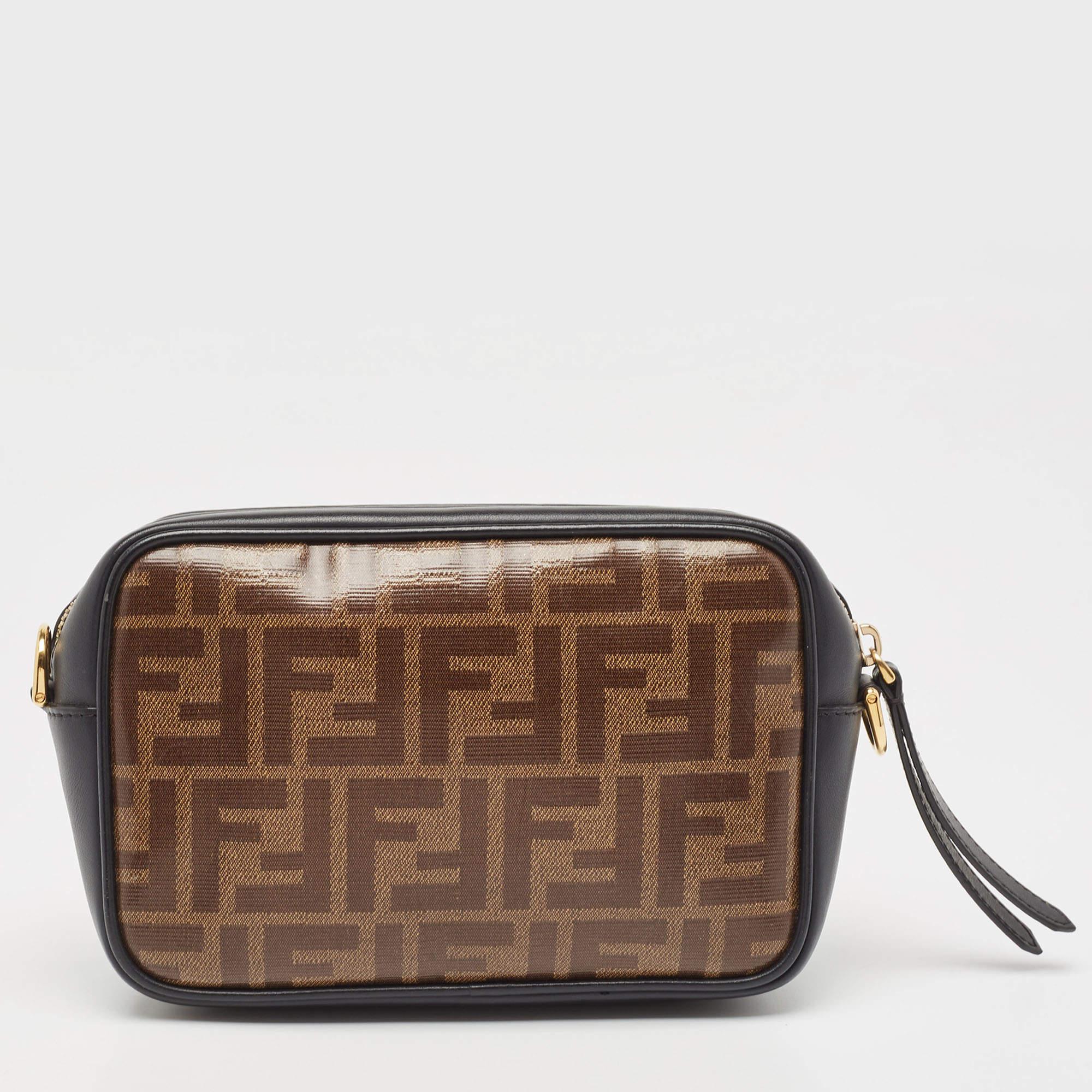 This Fendi handbag will elevate your style quotient and take it a notch higher. Carry this camera bag without compromising on style. This Zucca canvas & leather bag comes in a simple style with the logo on the front. This chic bag opens to a