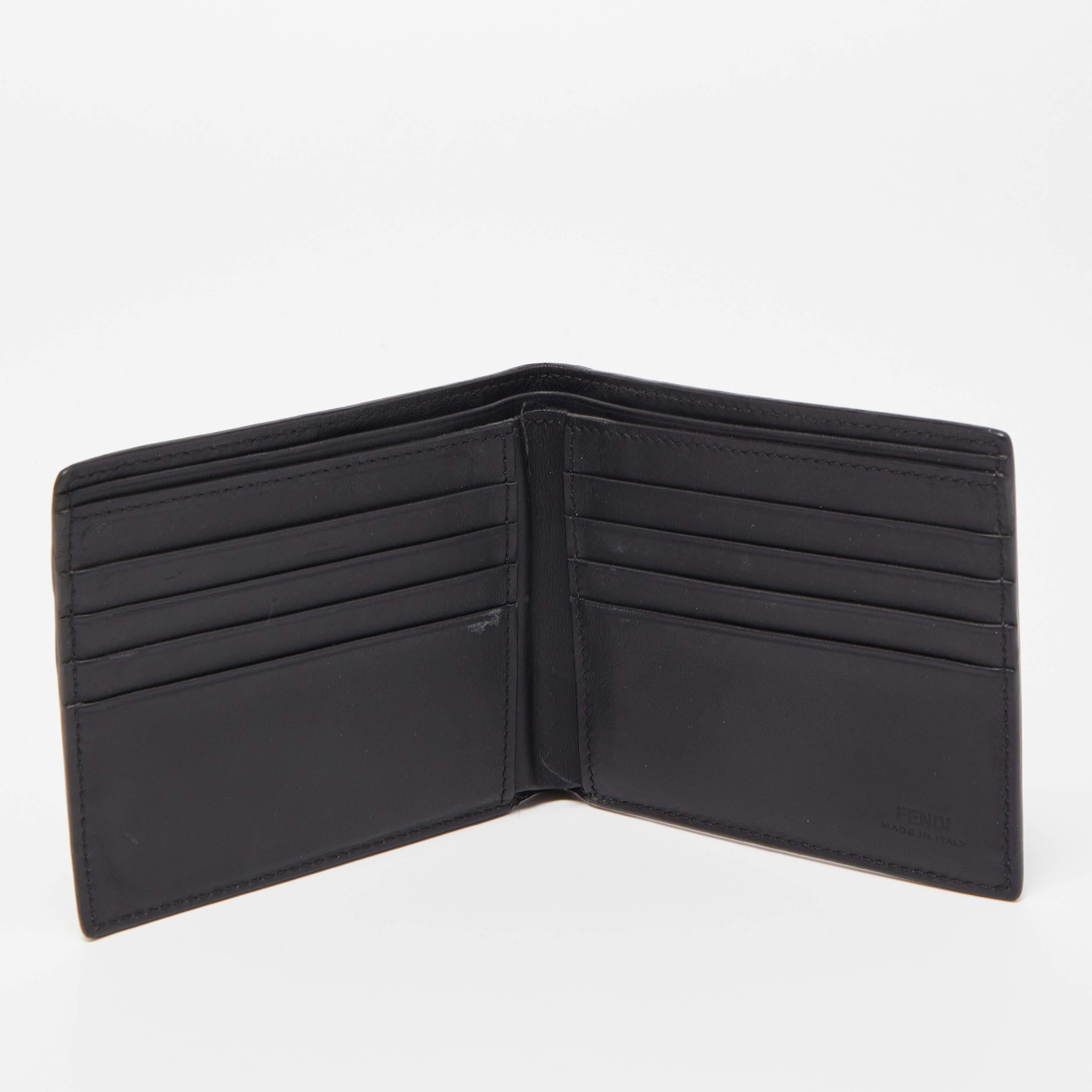 This Fendi tricolor bifold wallet is the most classy way to organize your essentials. The stunning leather creation is detailed with bag bugs eyes accents and features compartmentalized interior to keep your monetary essentials organized.