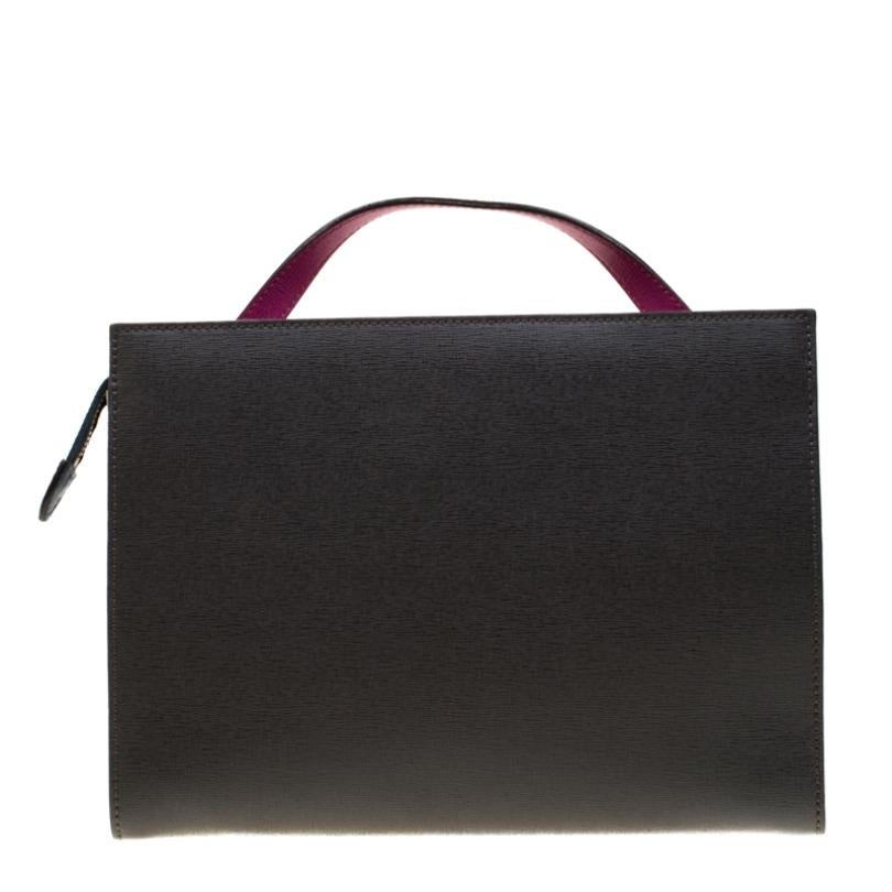 This Demi Jour top handle bag by Fendi is not only lovely to look at but is also handy and durable. It has been crafted from tri-colour textured leather and styled very artistically with a flap compartment in the front and a zipper one at the back.