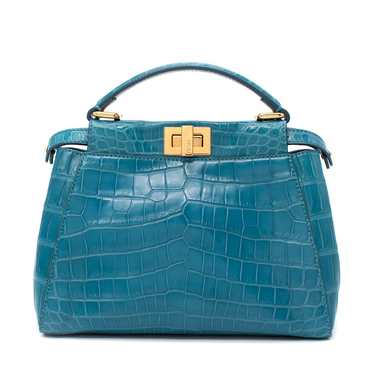 Fendi Turquoise Crocodile Mini Peekaboo Bag

-  Decorated with the iconic twist lock on both sides
- Featuring a soft, tone on tone nappa leather lining
- Two compartments separated by a stiff partition
- Inner zip pocket and gold-finish metalware
-